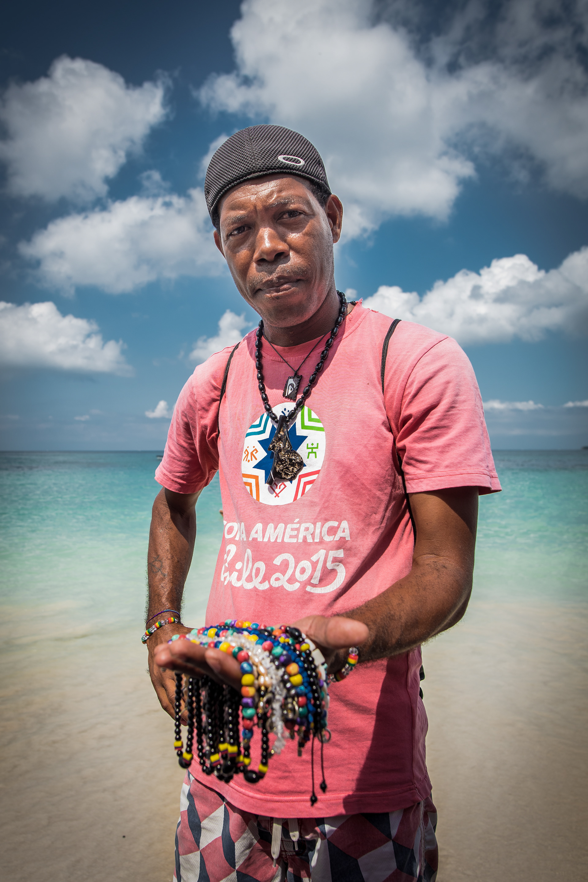 A man selling beaded jewelry in Baru Island in Cartagena, Colombia