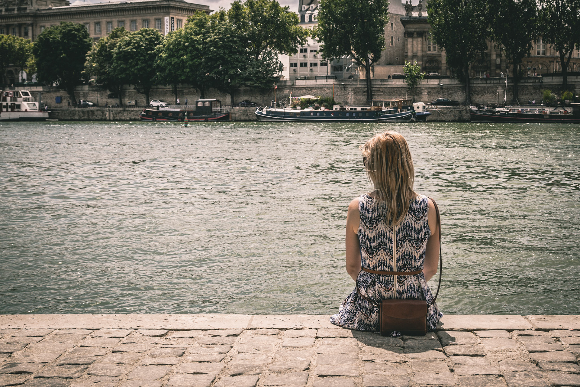 Young woman looking the Seine in Paris, France