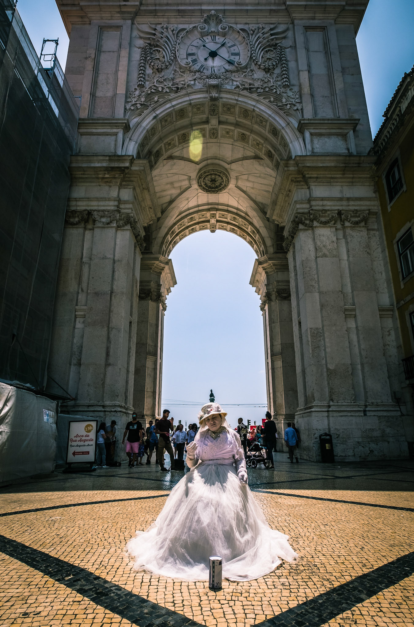 Famous arch at the Praca do Comercio, Lisbon, Portugal, with a street performer.