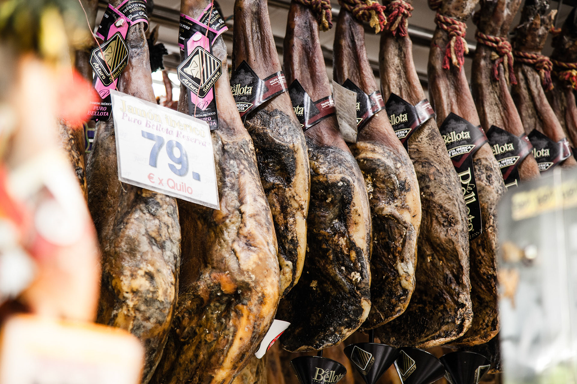 Jamon Iberico, spanish ham, hanging at local butcher in Boqueria market, Barcelona, Spain