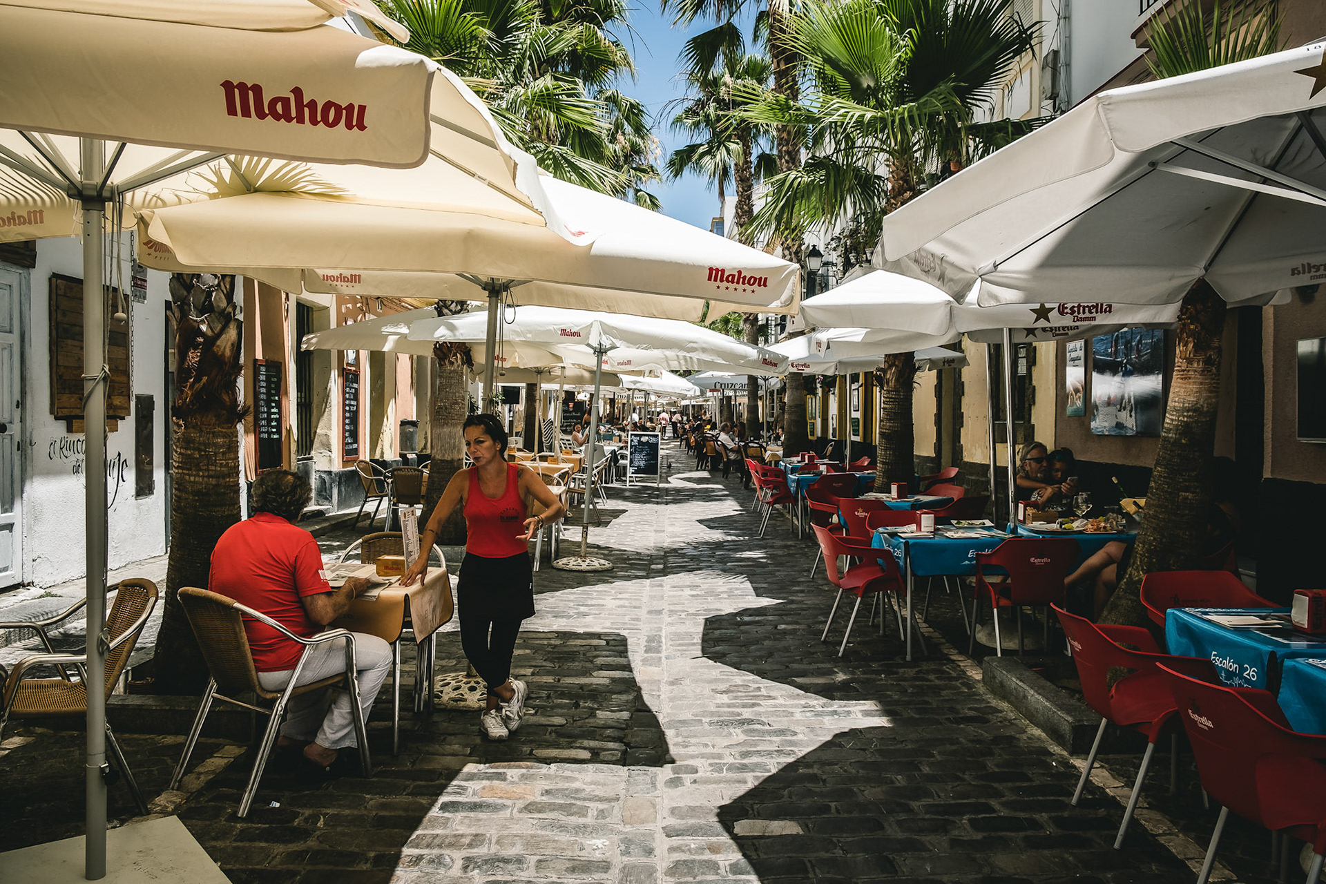 Tourists and locals at the beautiful and historic streets of Cadiz, Spain.
