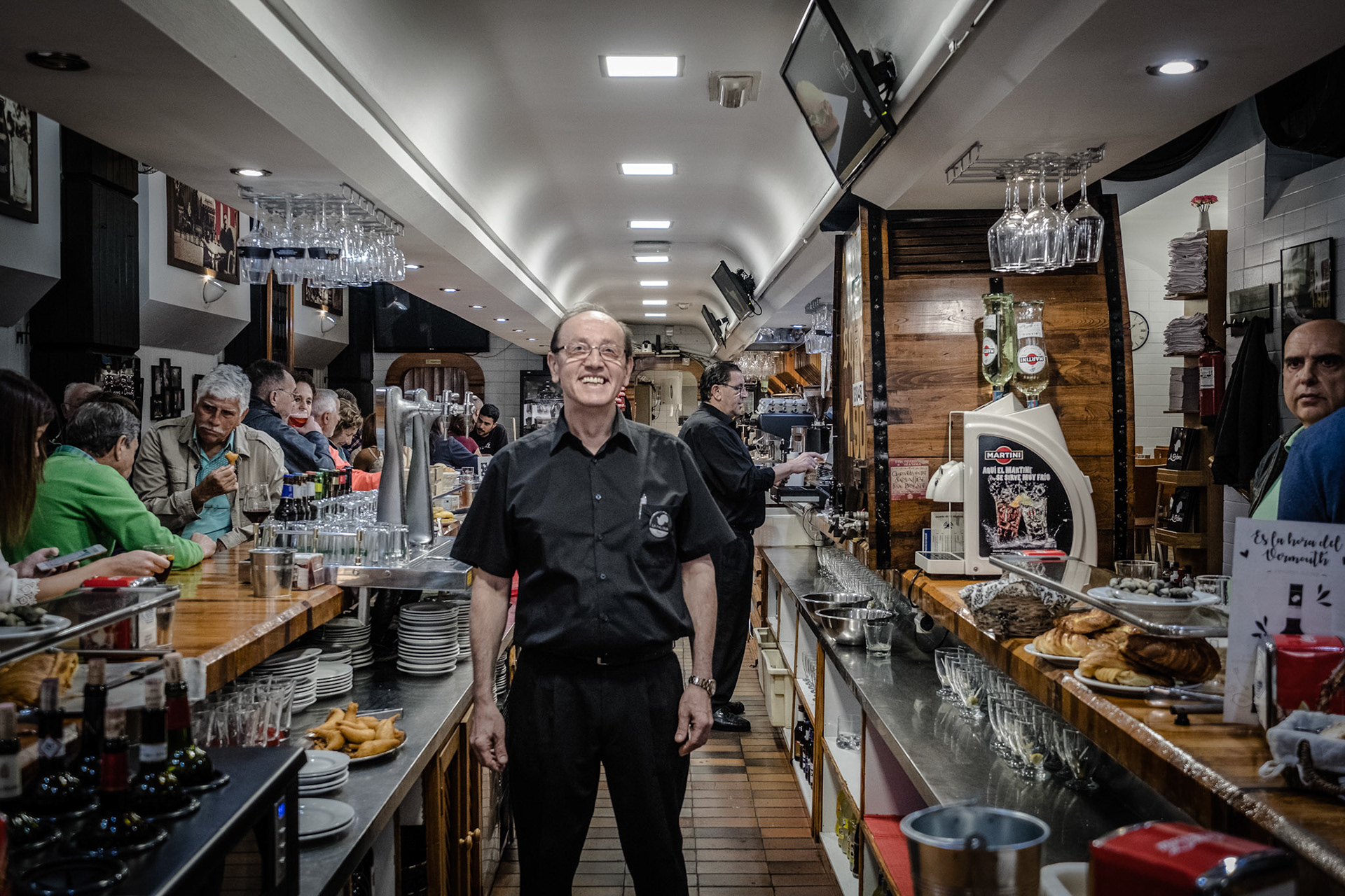 La Paloma, Vermouth of solera and prawns gabardine in busy house founded in 1900 with old advertising posters. Oviedo, Spain.