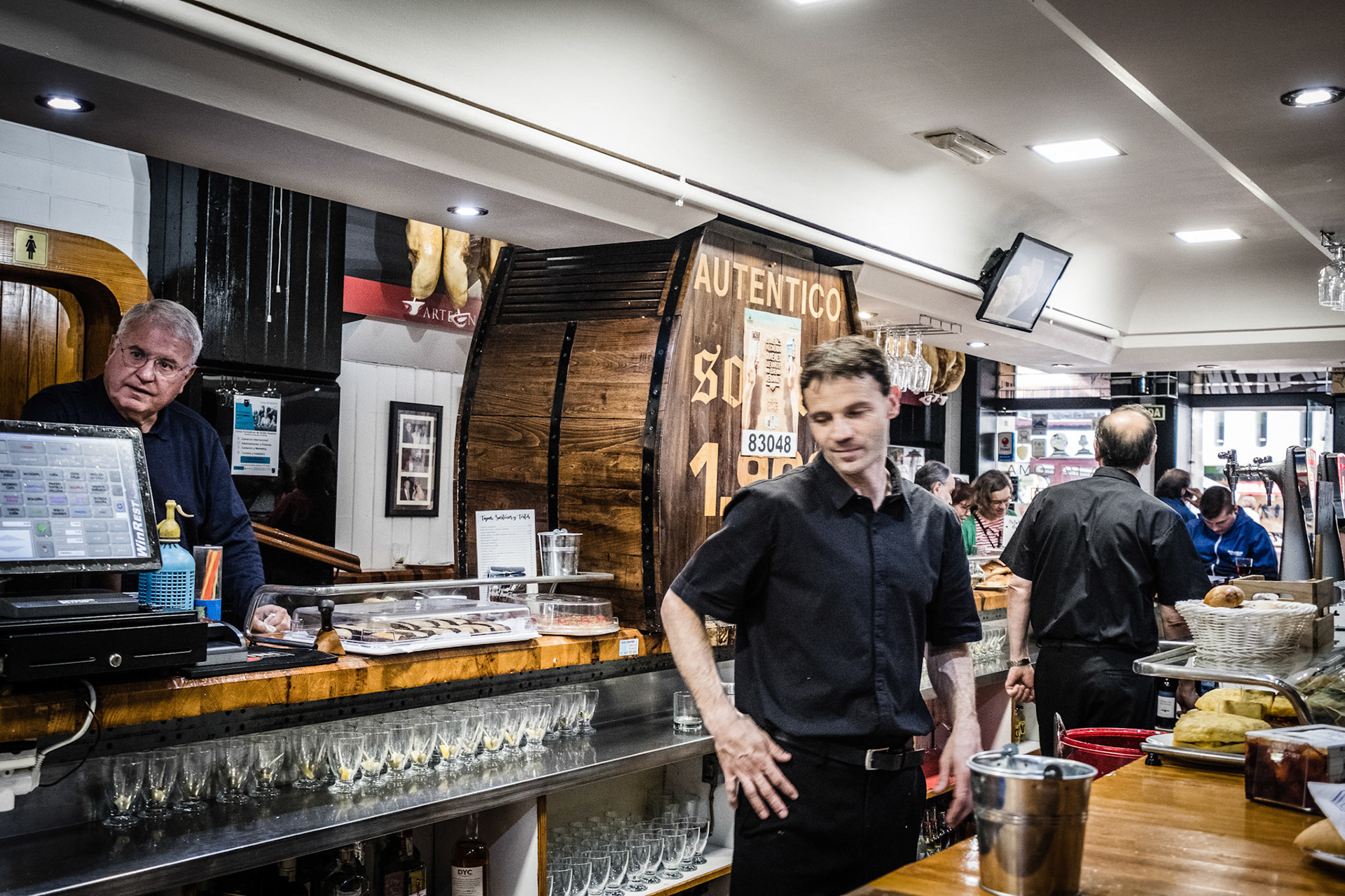 La Paloma, Vermouth of solera and prawns gabardine in busy house founded in 1900 with old advertising posters. Oviedo, Spain.