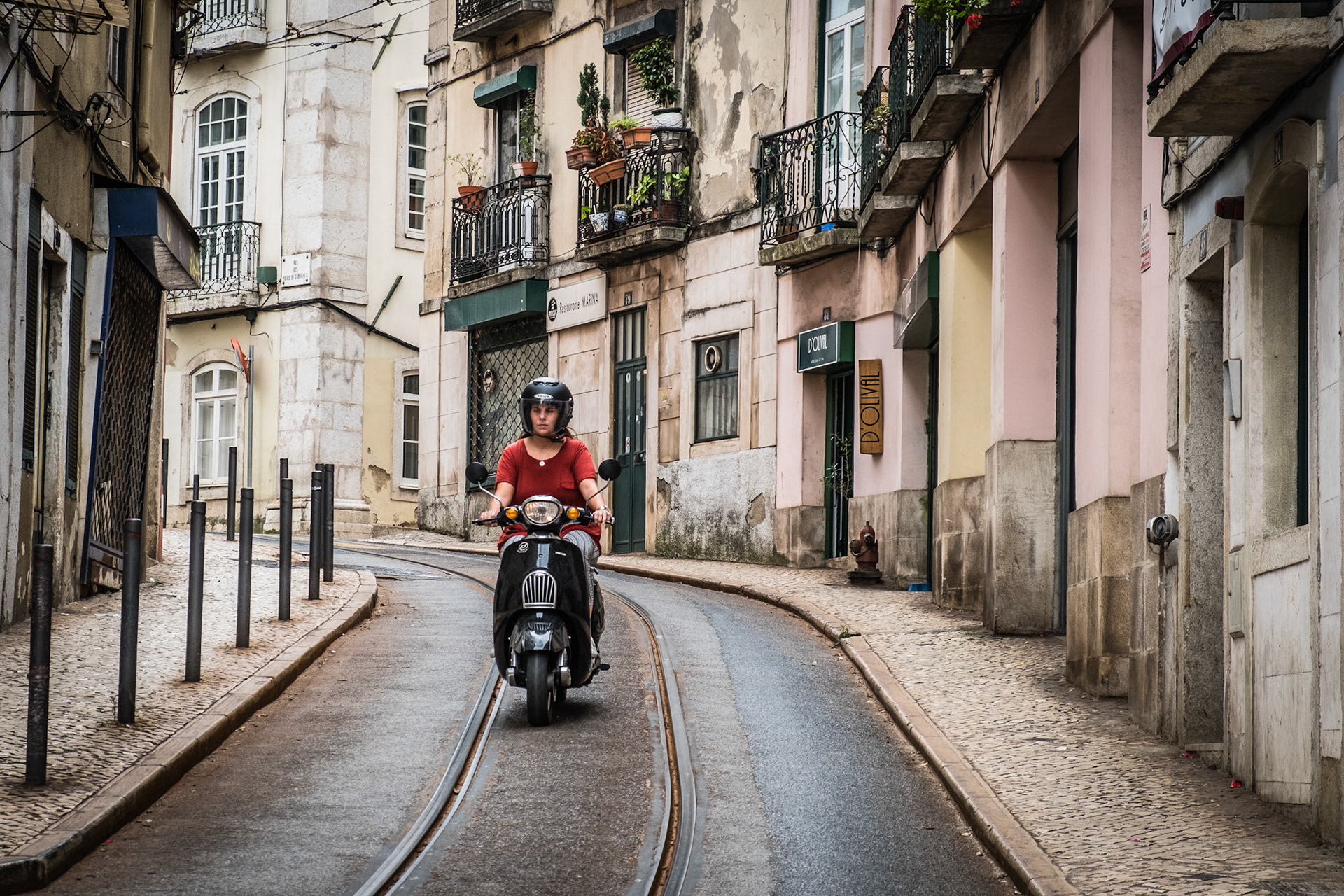 Old colorful houses and narrow streets of Lisbon, Portugal in Spring. Beautiful facades and old street lights.