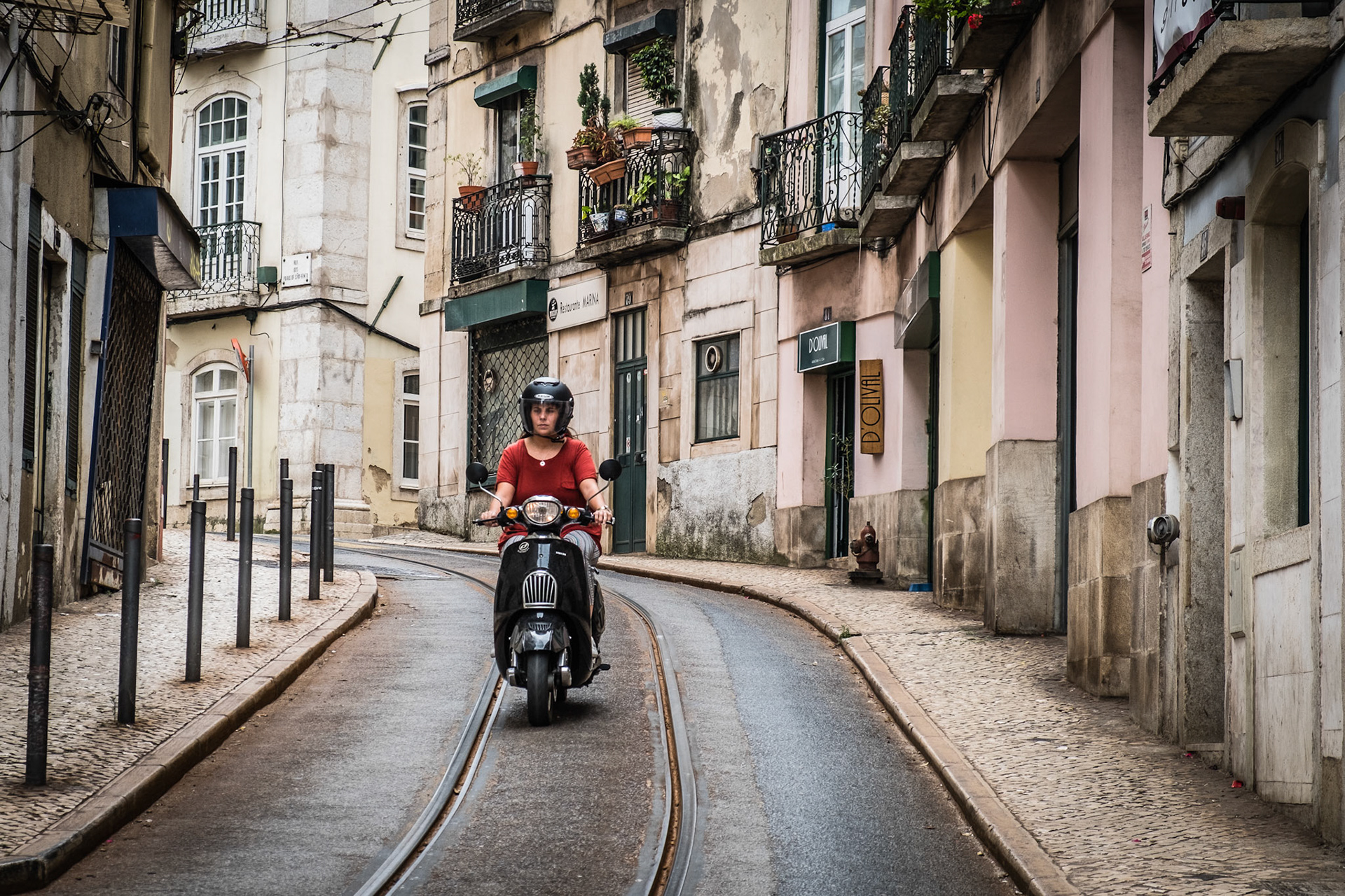 Old colorful houses and narrow streets of Lisbon, Portugal in Spring. Beautiful facades and old street lights.