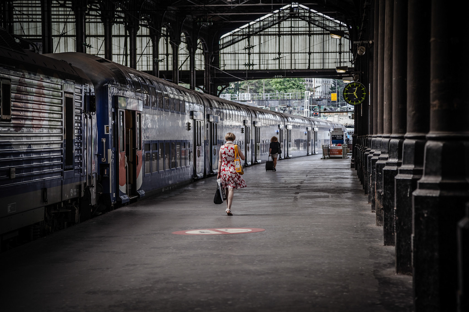 Woman Walkin alone to take her train, Gare Saint-Lazare, Paris, France.
