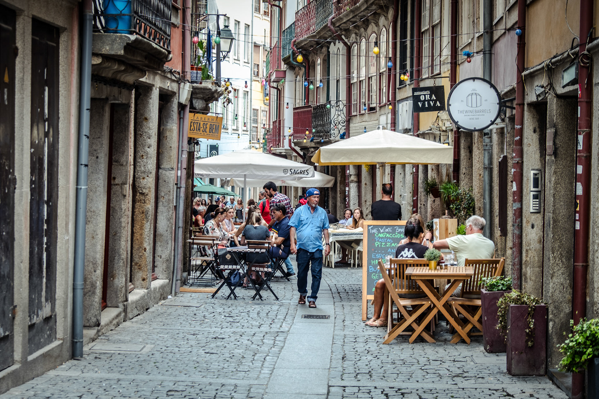 Tourists and locals walking the streets of Porto, Portugal. Porto is the 2nd largest city in Portugal. Its old town is a UNESCO World Heritage Site.