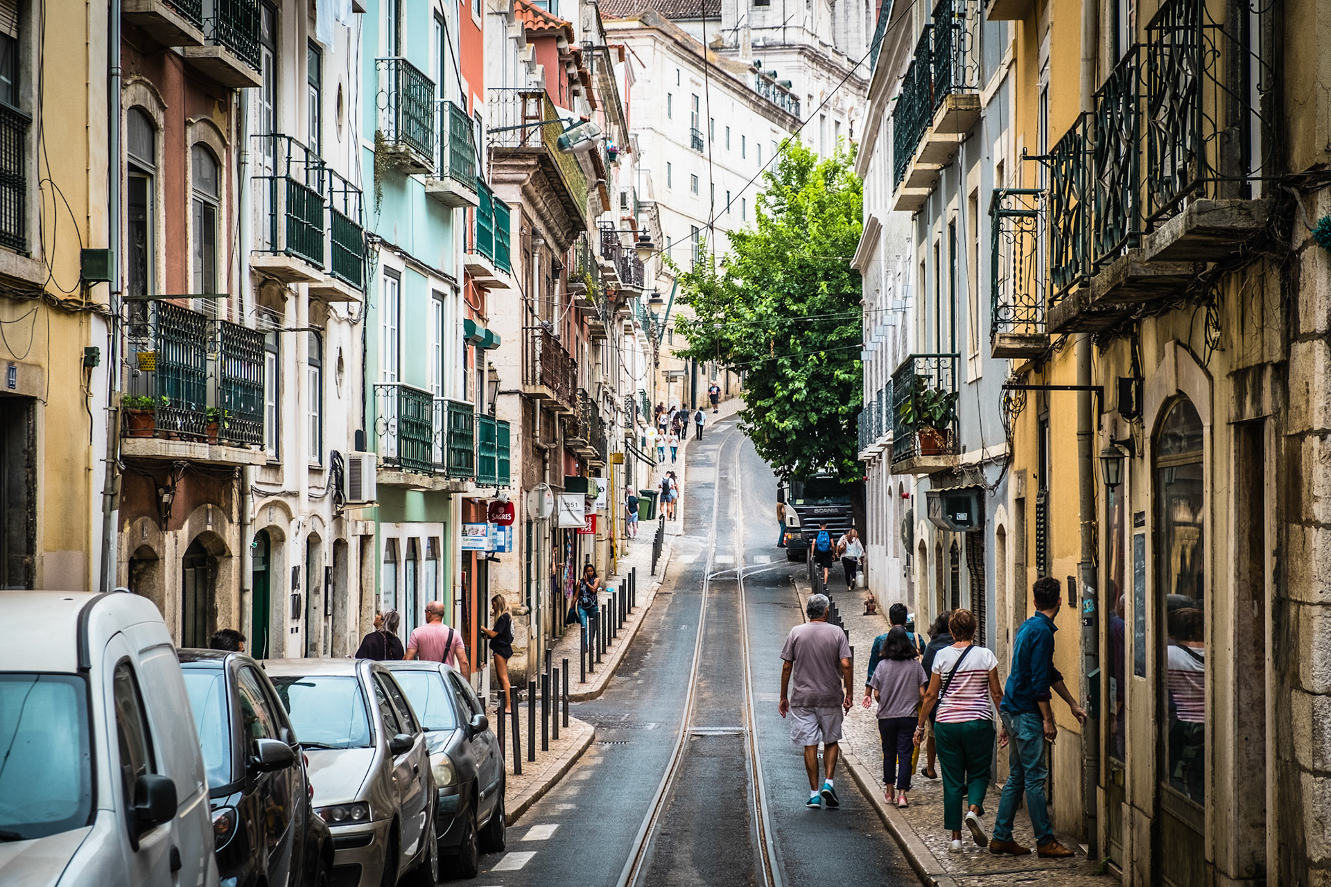 Old colorful houses and narrow streets of Lisbon, Portugal in Spring. Beautiful facades and old street lights.