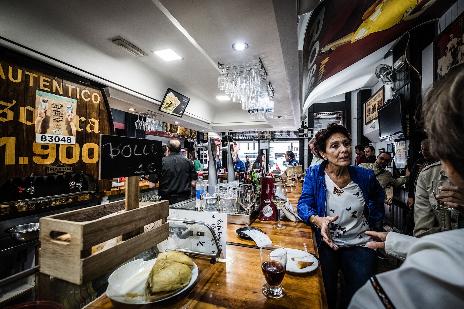 La Paloma, Vermouth of solera and prawns gabardine in busy house founded in 1900 with old advertising posters. Oviedo, Spain.