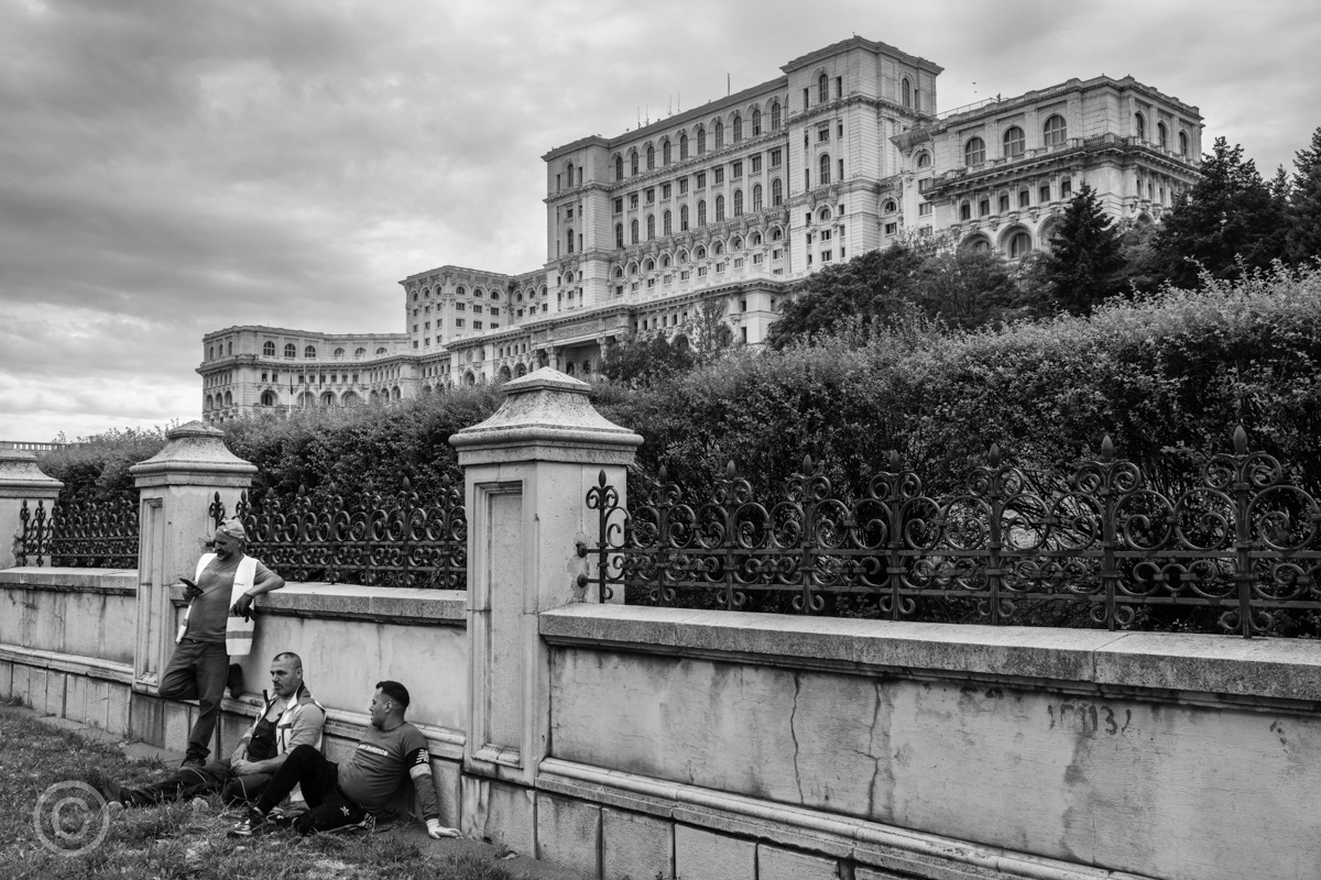 Workmen taking a break outside the Palace of the Parliament, Bucharest, Romania