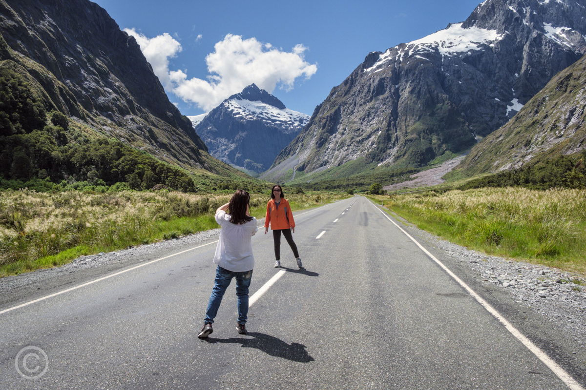 Tourists stop for a photo on the Milford Sound Highway at Monkey Creek