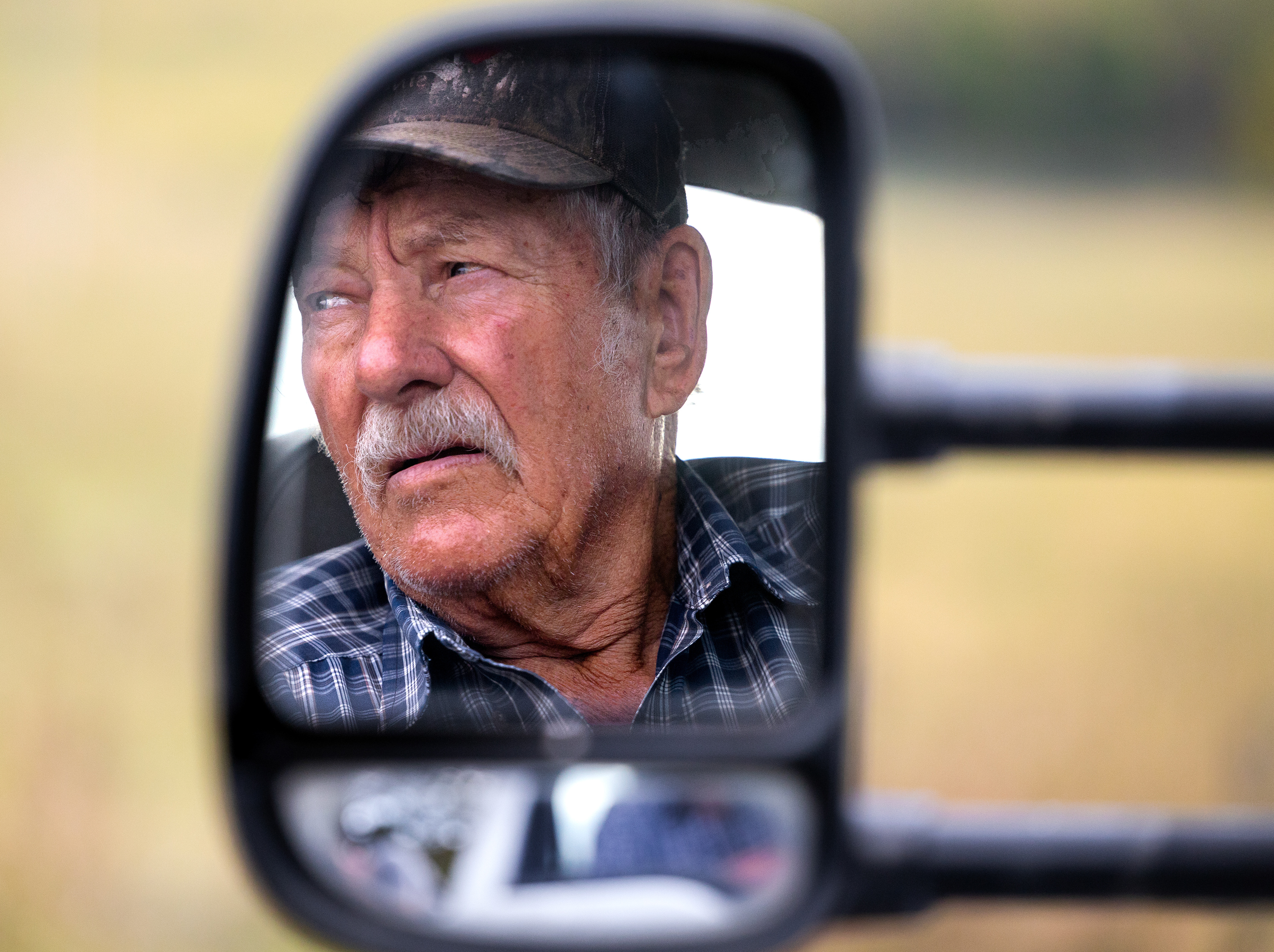 Martin Henson looks out his window as he pulls a trailer of hay behind him, on Friday Oct. 13, 2023, in Franklin County, Kentucky. Photo by Matthew Mueller