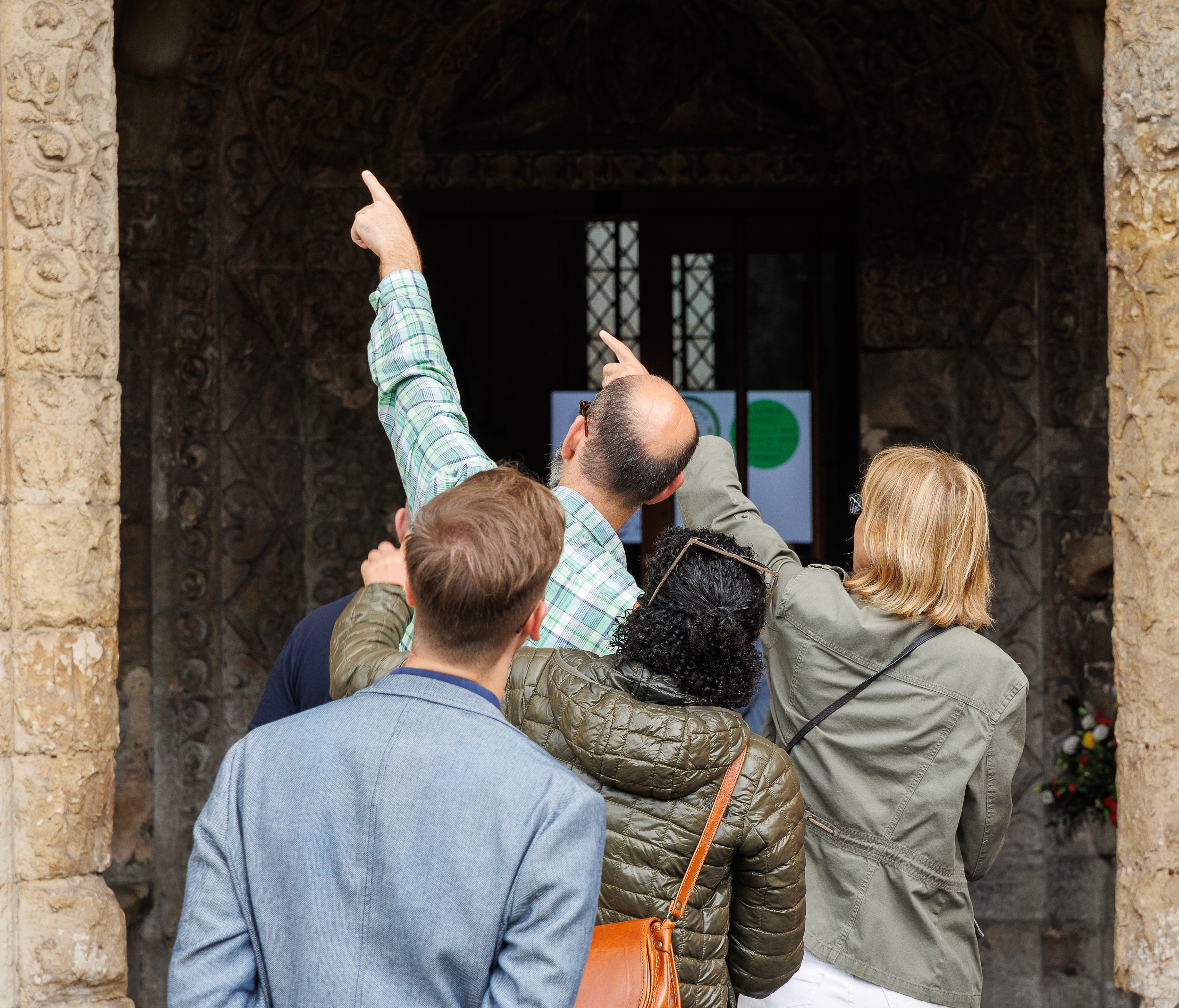 Pointing out the details of the Norman porch