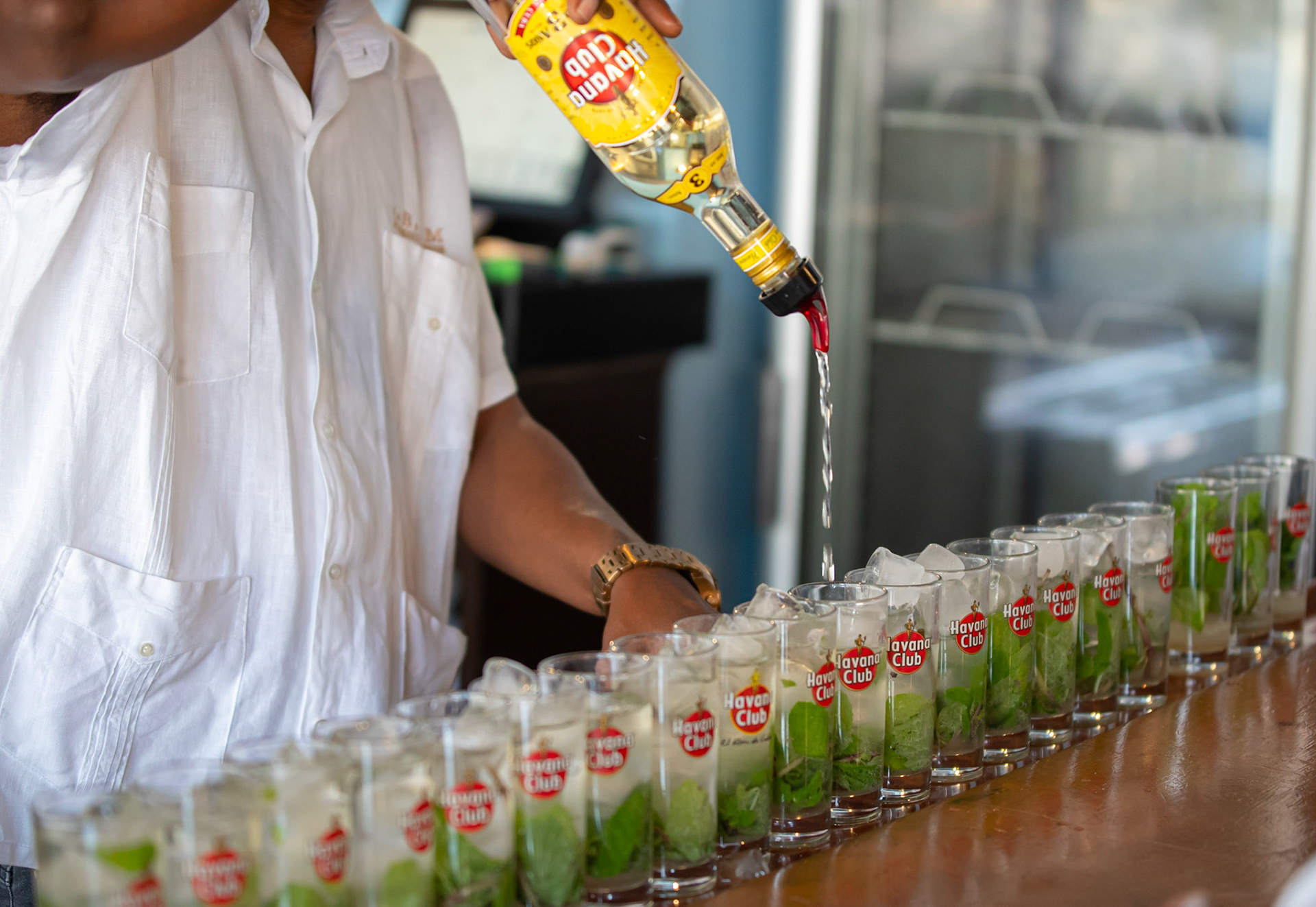 Pouring rum, the favourite national drink to make Mojitos