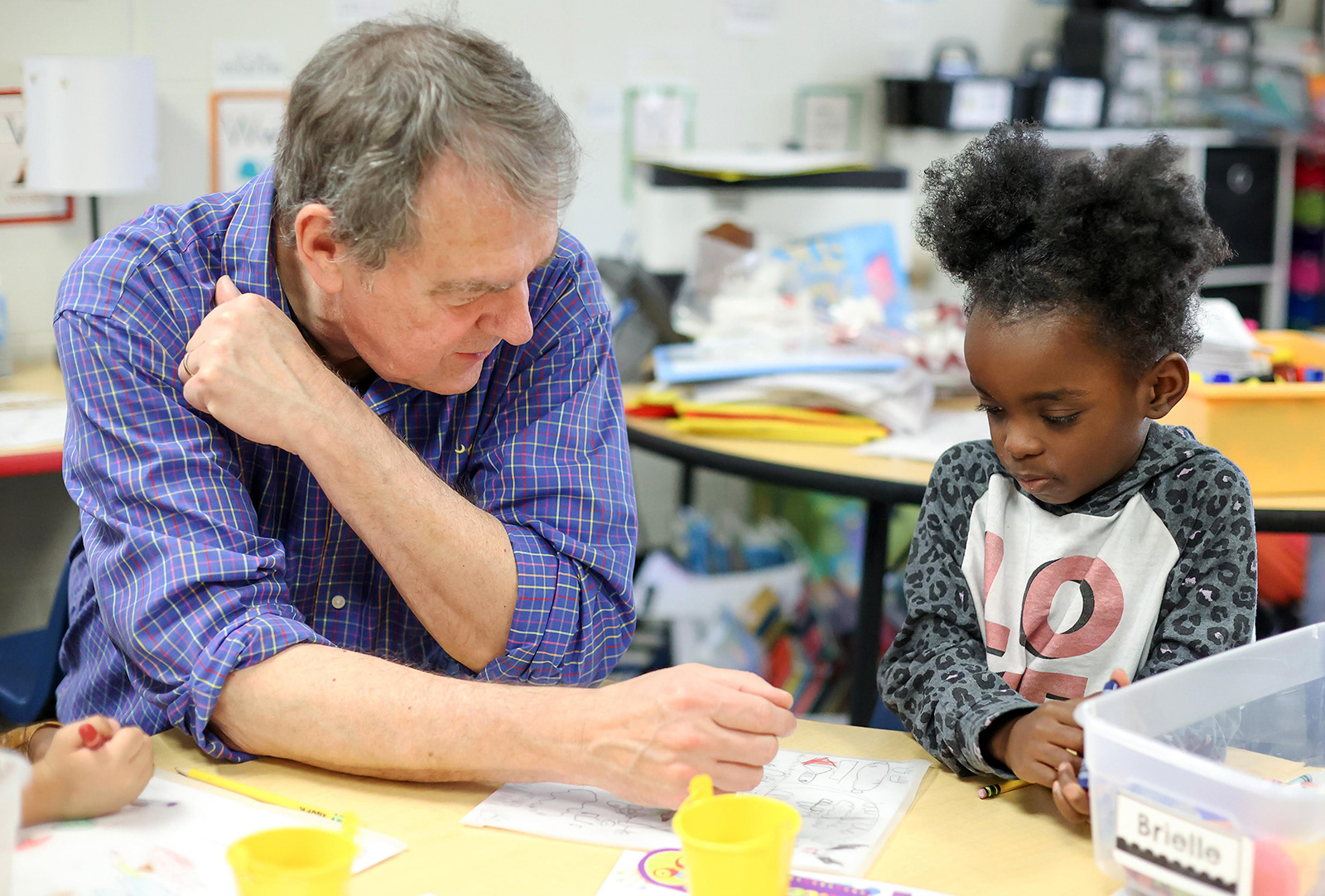 Tim does directed drawing with students from K through 5th