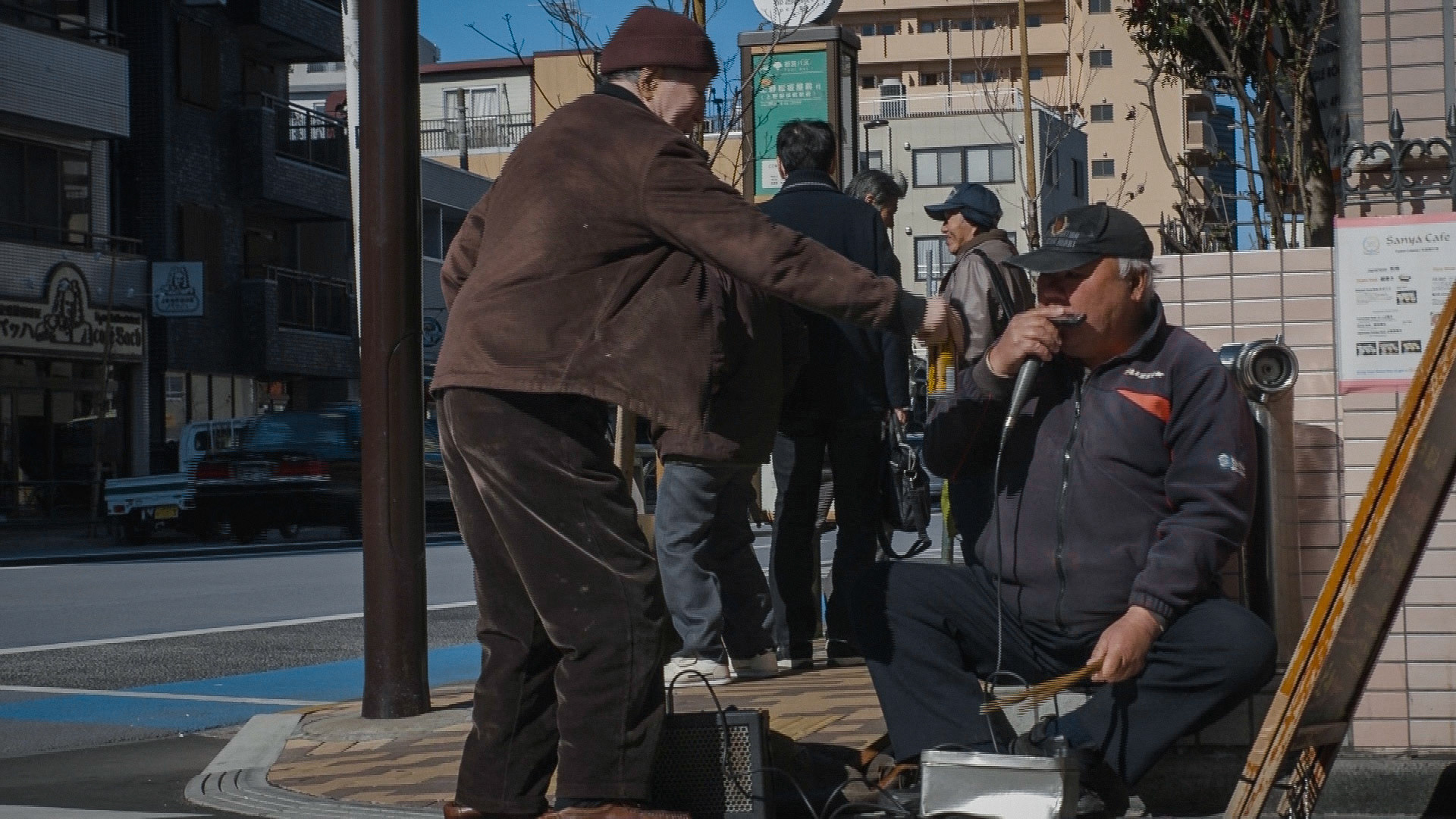 Harmonica 9 | A man giving a coffee firstly refused Ishino's passionate request for cigarettes, saying "I can't afford them!!" and left, but came back soon with a can of coffee and gave it to Ishino, saying "but I have only this for you", grnning, 10 April 2020.