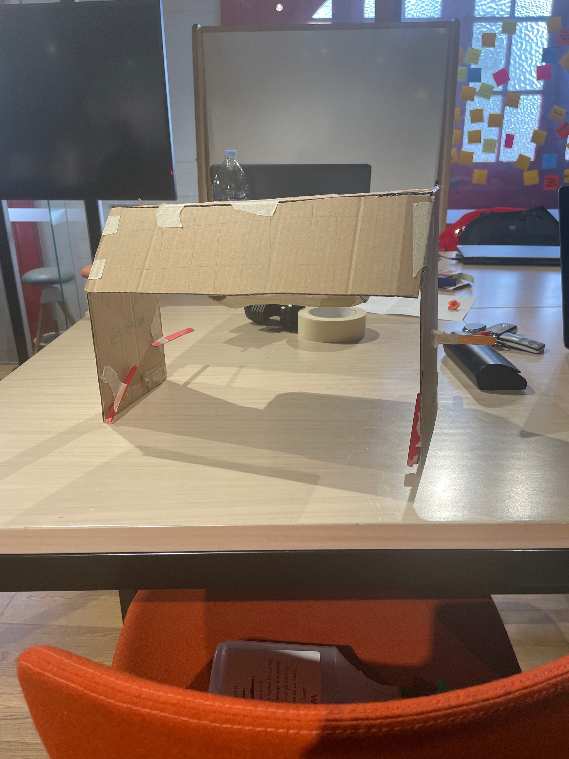 Universal Design in the Kitchen, Domestic Dough Sheeter Prototype. Created with cardboard, masking tape, popsticks and paper. Front view.