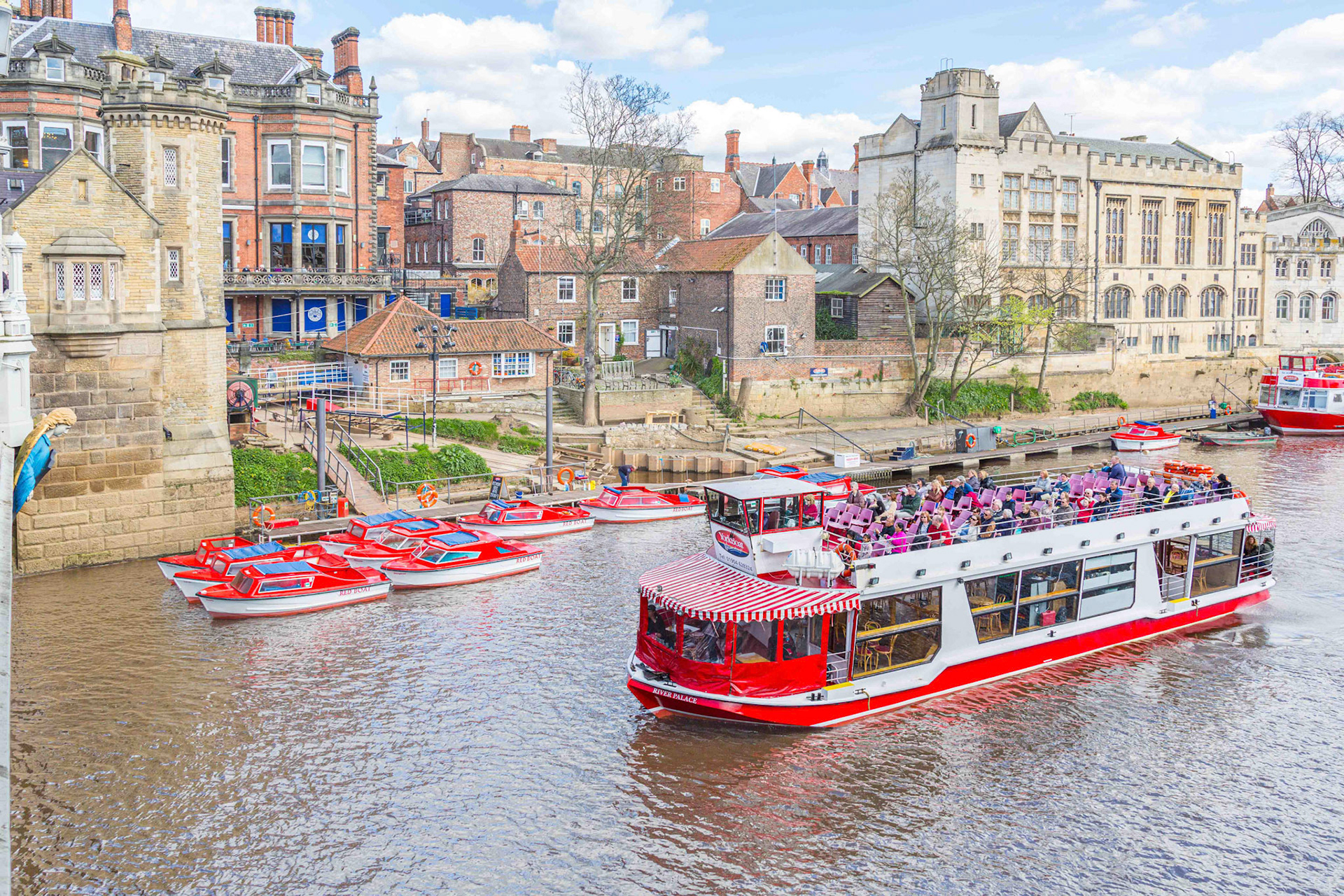 Pleasure Cruise Boats along the Ouse showing the Lendal Bridge Angel  - York UK