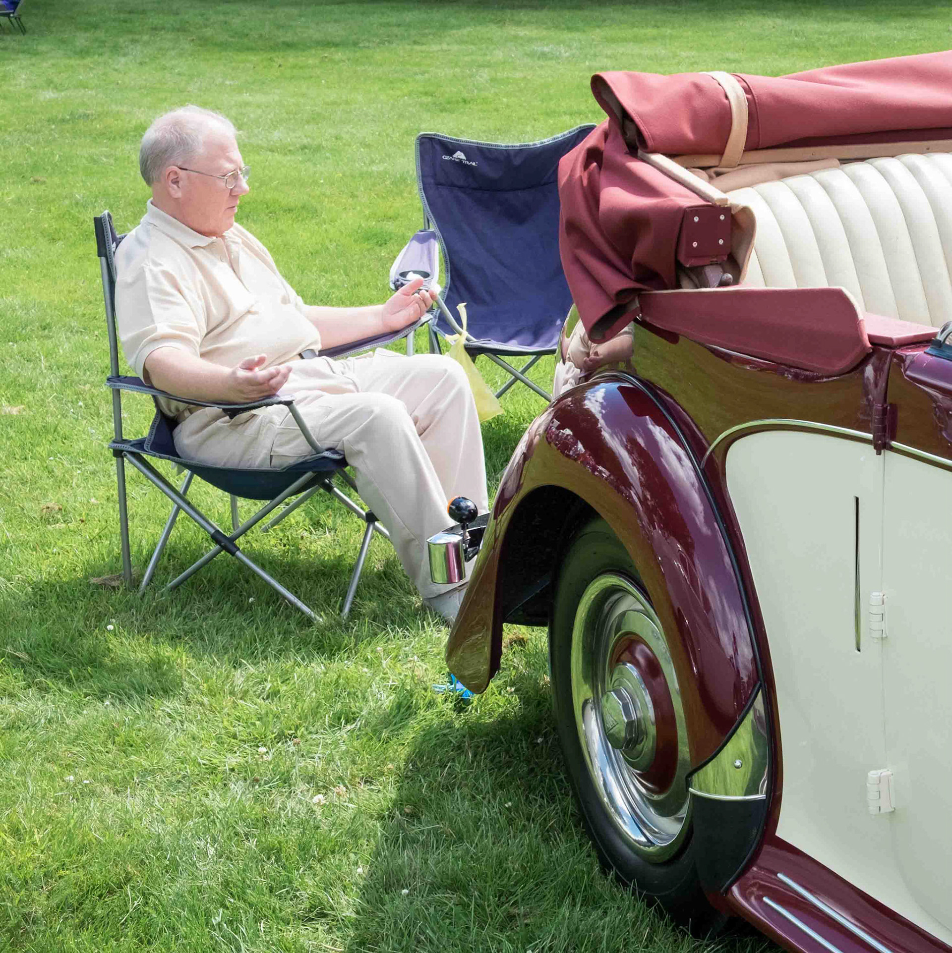 Man Sat Near Classic Car - Harewood Leeds West Yorkshire UK