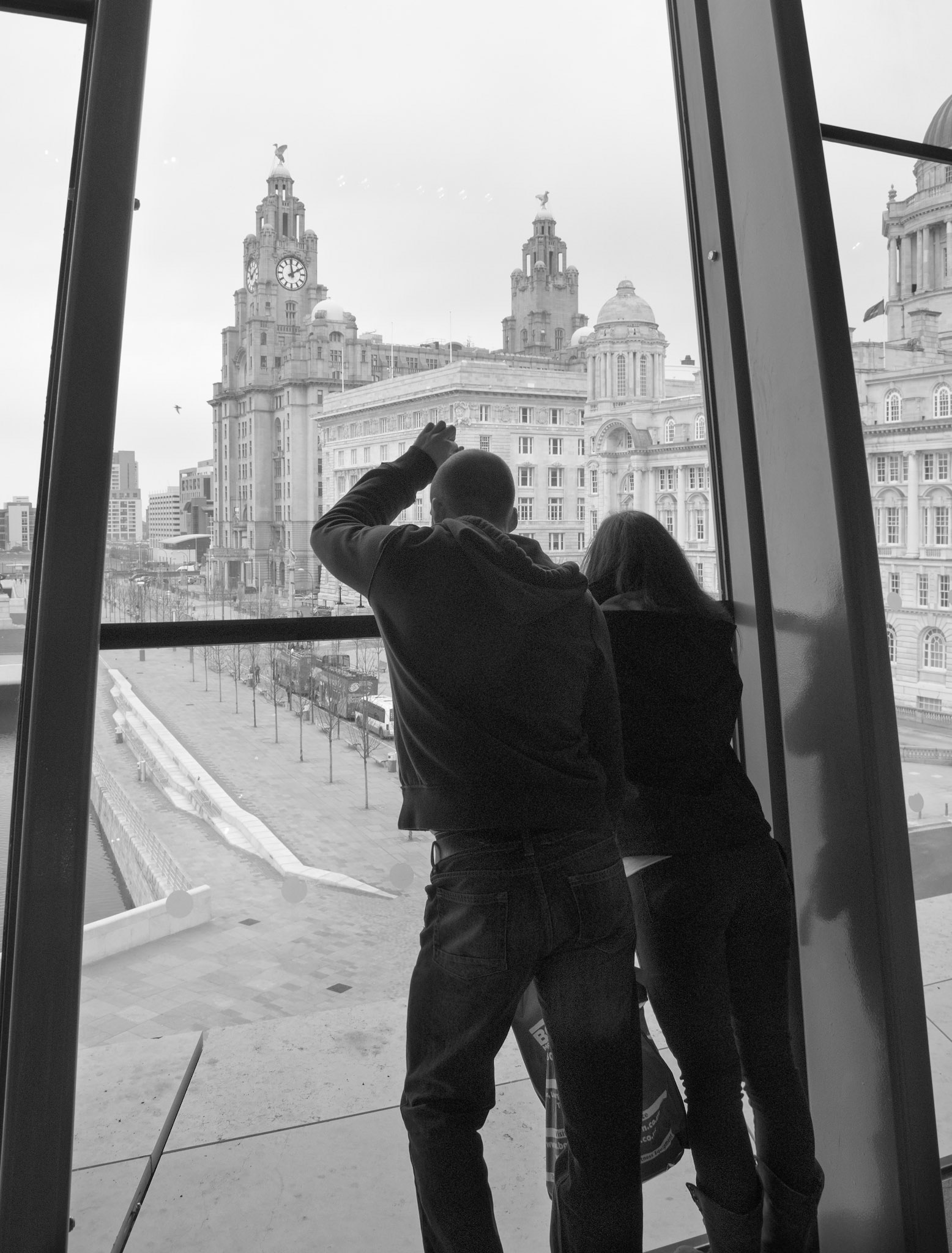Liverpool Couple - Looking Out Of Building Liverpool Merseyside UK