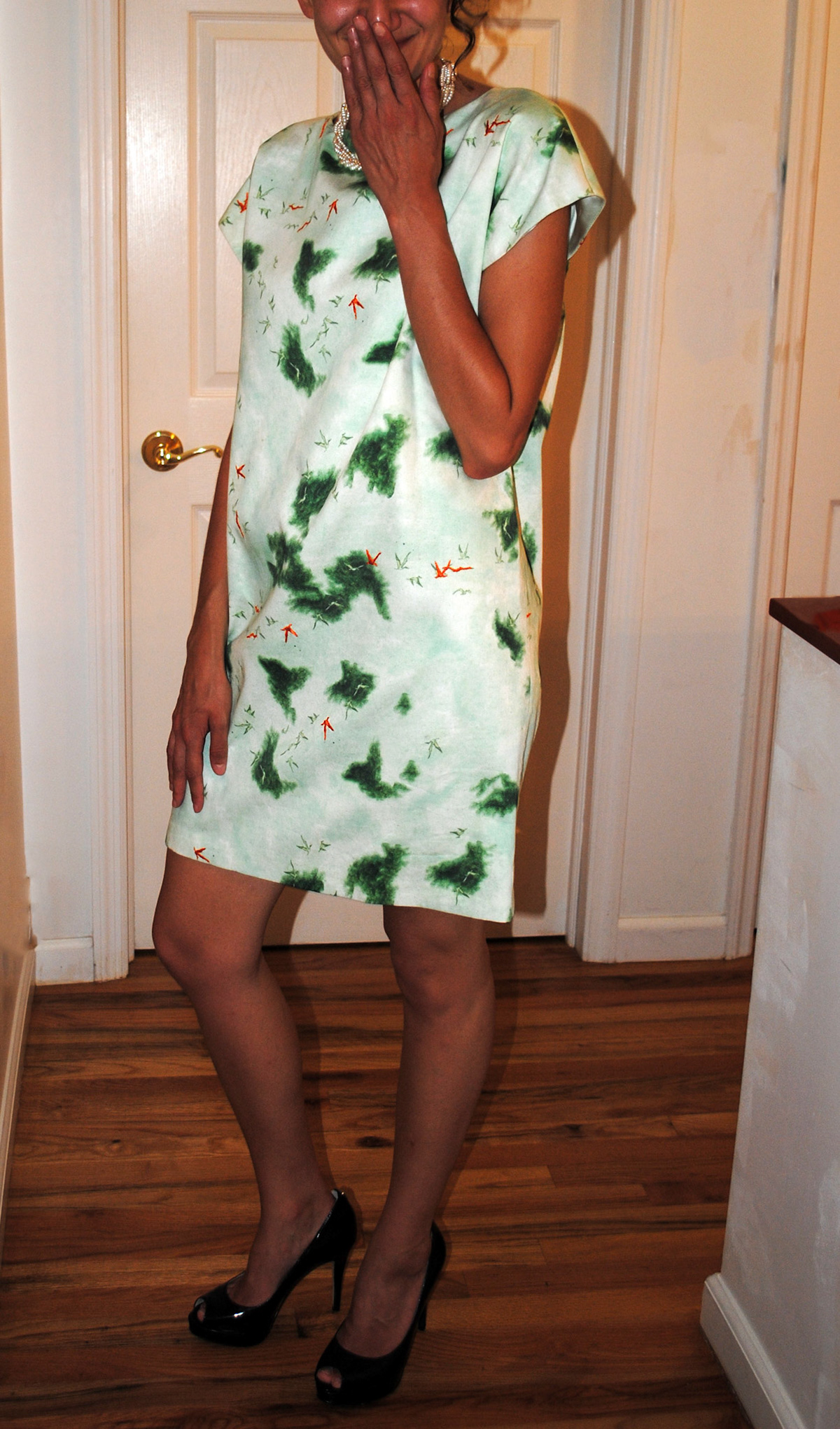 Custom print, cotton sateen shift dress hand embroidered with orange silk thread and lined with silk charmeuse. Custom Golden button closure. Styled with custom necklace.