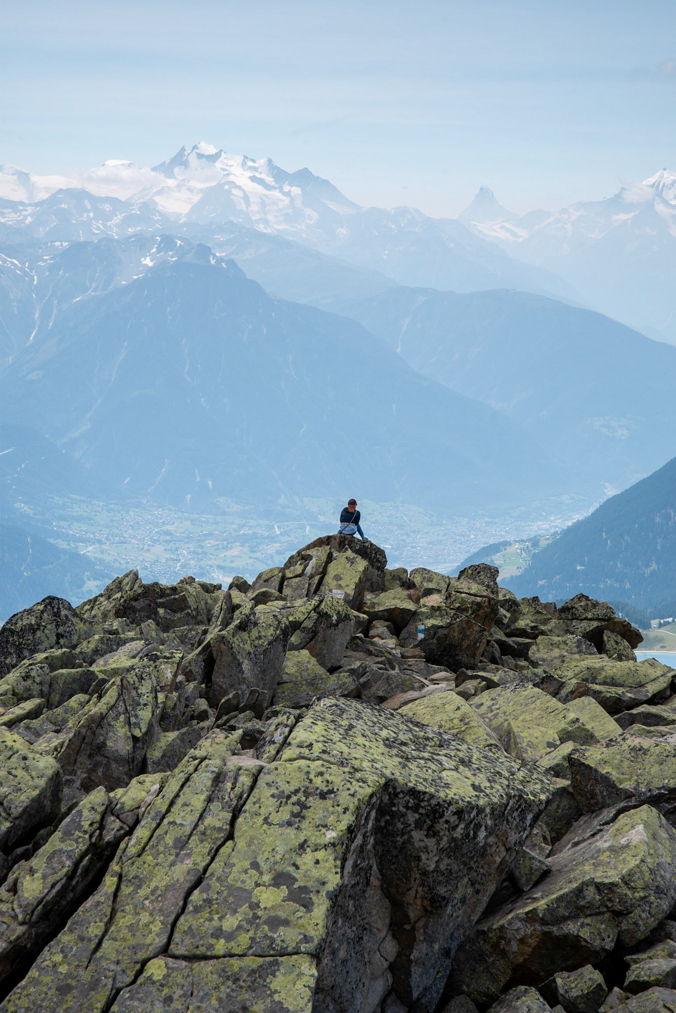 My daughter, sitting on the Bettmerhorn, taking in the greatness of the world. Matterhorn in the background.