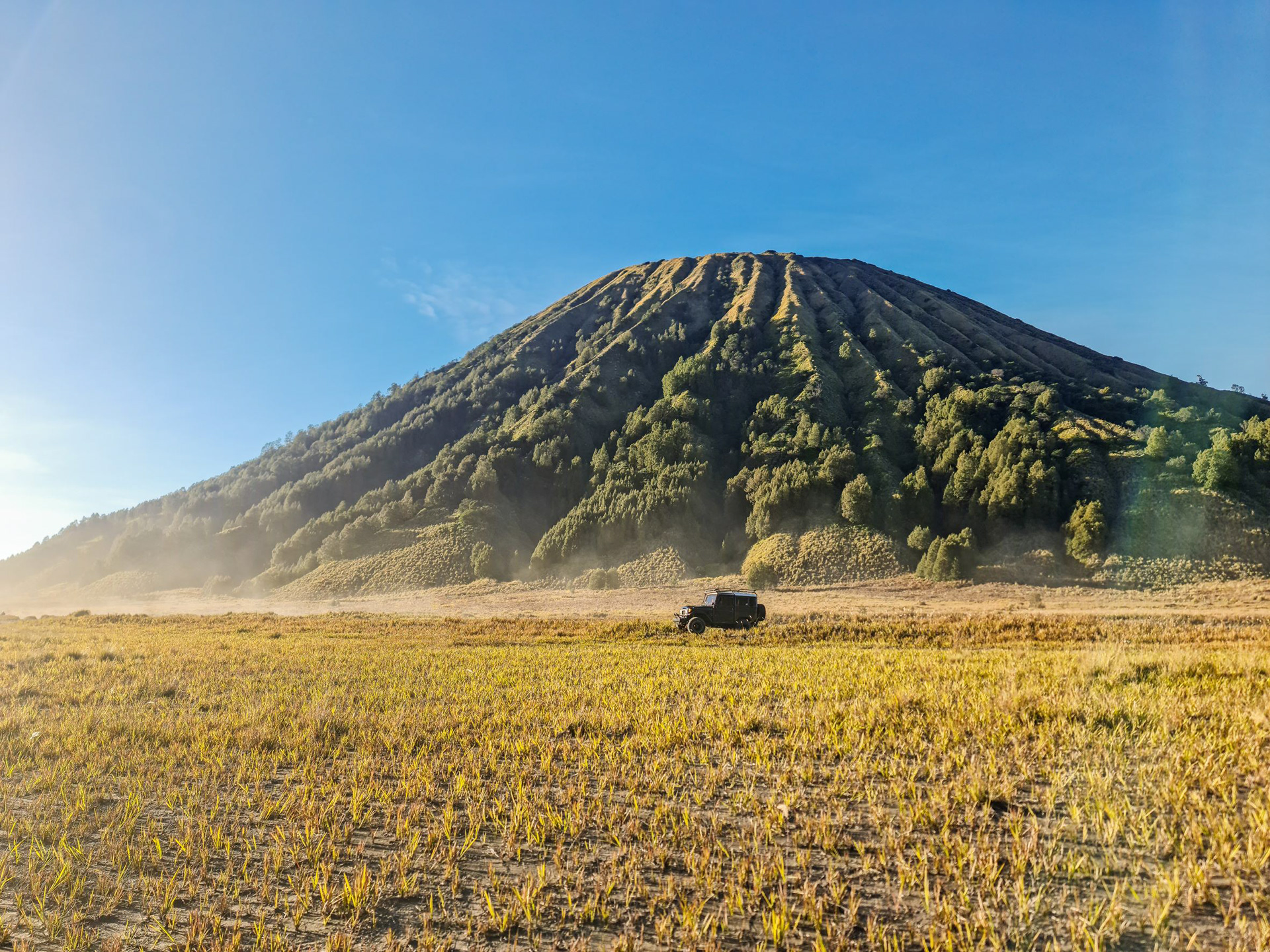 A 4x4 Jeep crossing the Sea Of Sand at Bromo Tengger Semeru National Park.