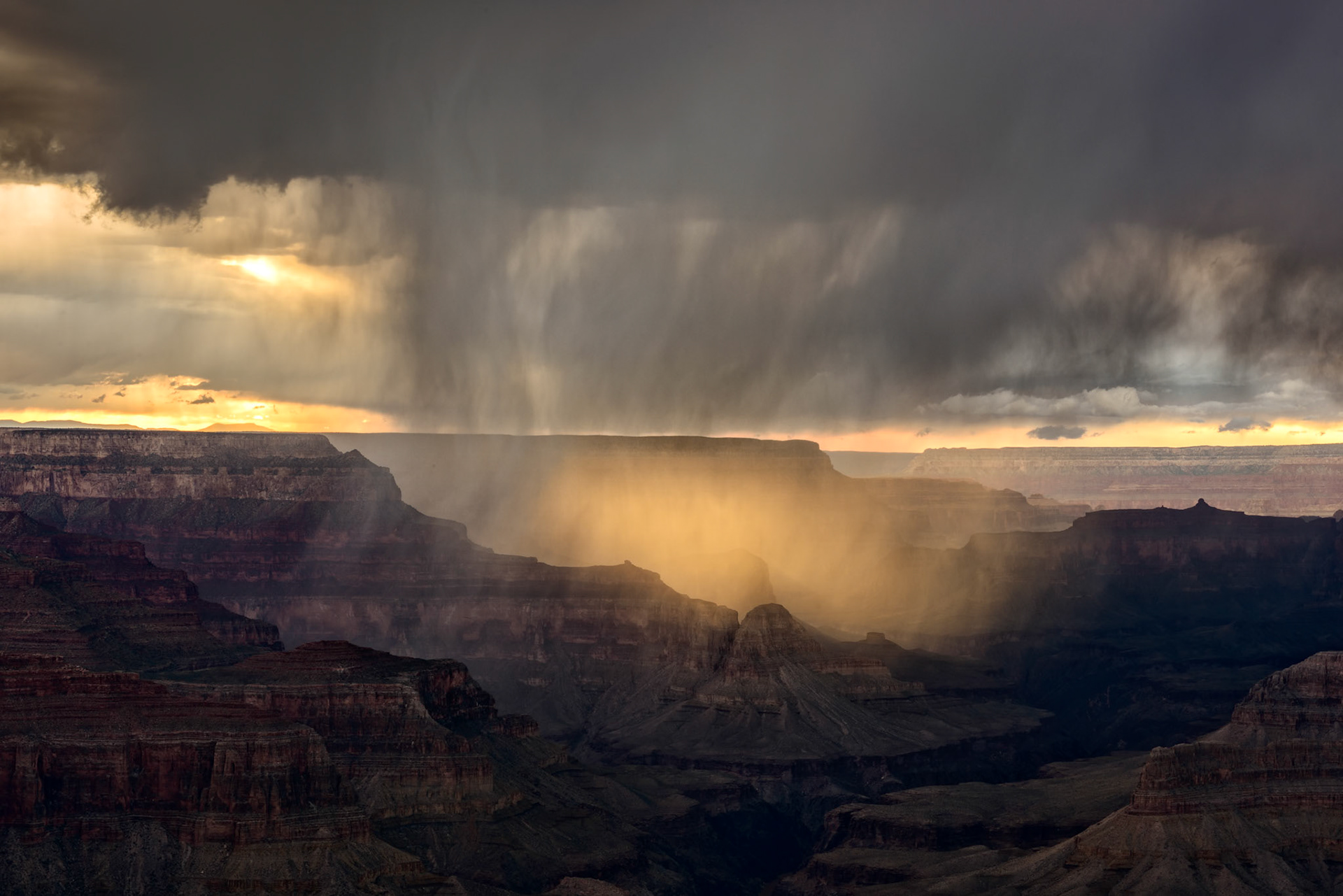 Waiting for sunset, I instead had the opportunity to capture the setting light through a storm cloud and watch the canyon glow.
