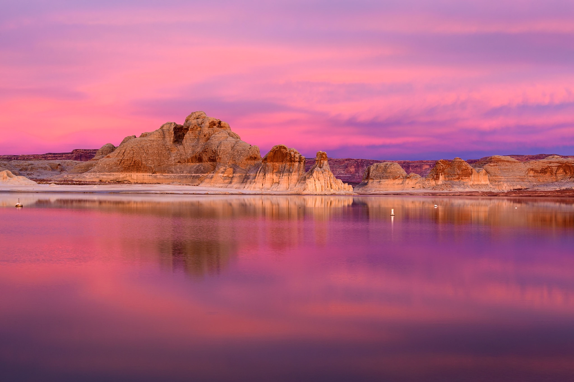 The water was calm and the clouds lit up perfectly to give the illusion of this promontory floating in the sky of color. Lake Powell, Page, Arizona.