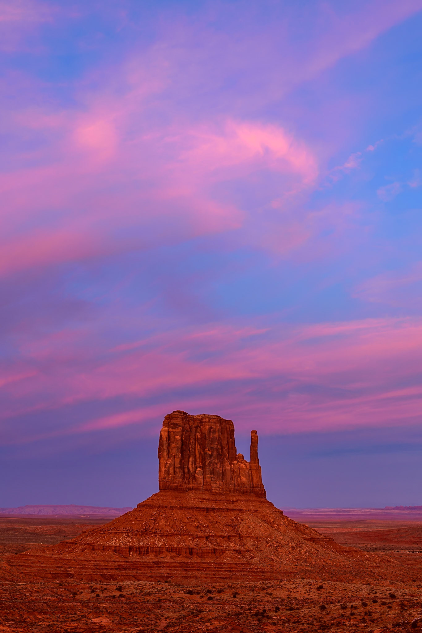 I have visited Monument Valley many times, but I have never seen a sunset like on this evening. The sky behind me was on fire.  After the sunset, the clouds glowed a beautiful pink which tinted the red rocks to a color I'd never seen before in the west. To capture the uniqueness of the color and beauty of the moment I focused on a simple mitten.