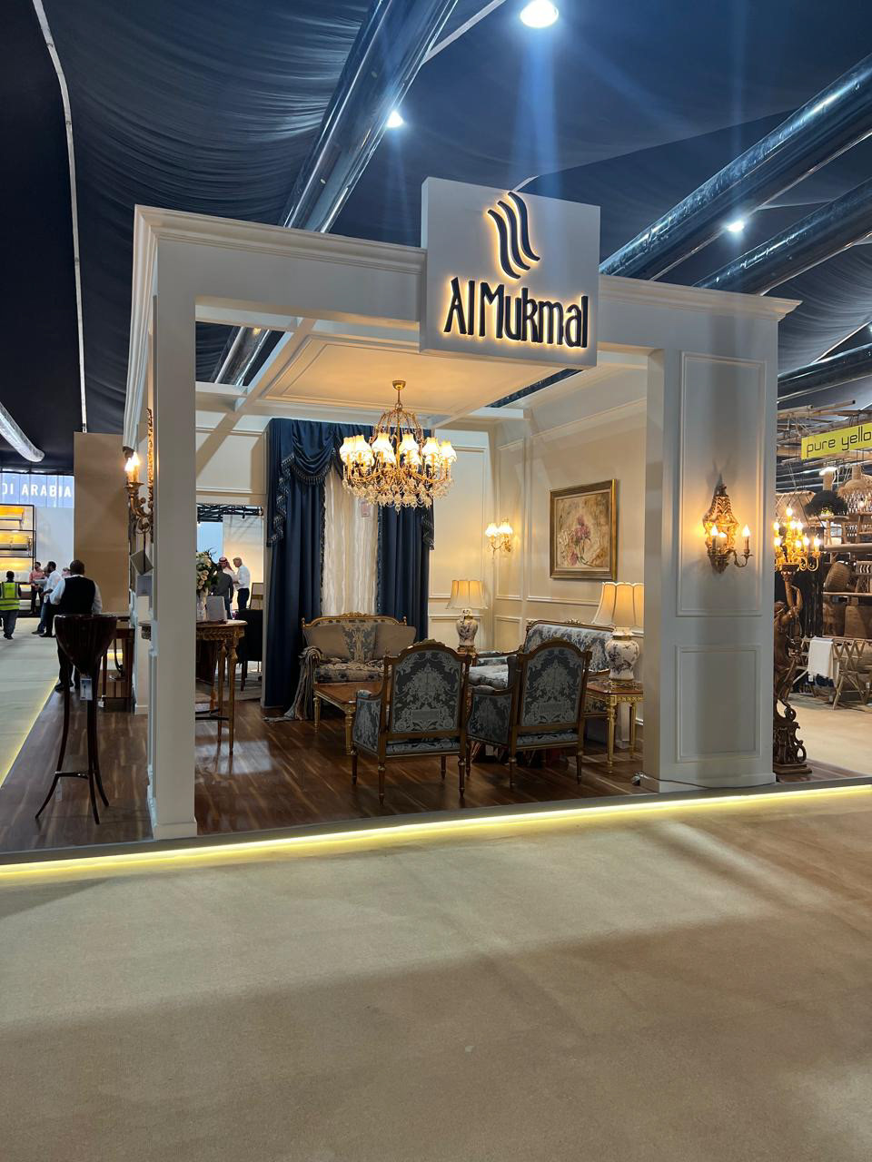 Far front view of the Al Mukmal booth, offering an overview of the unique space and design.