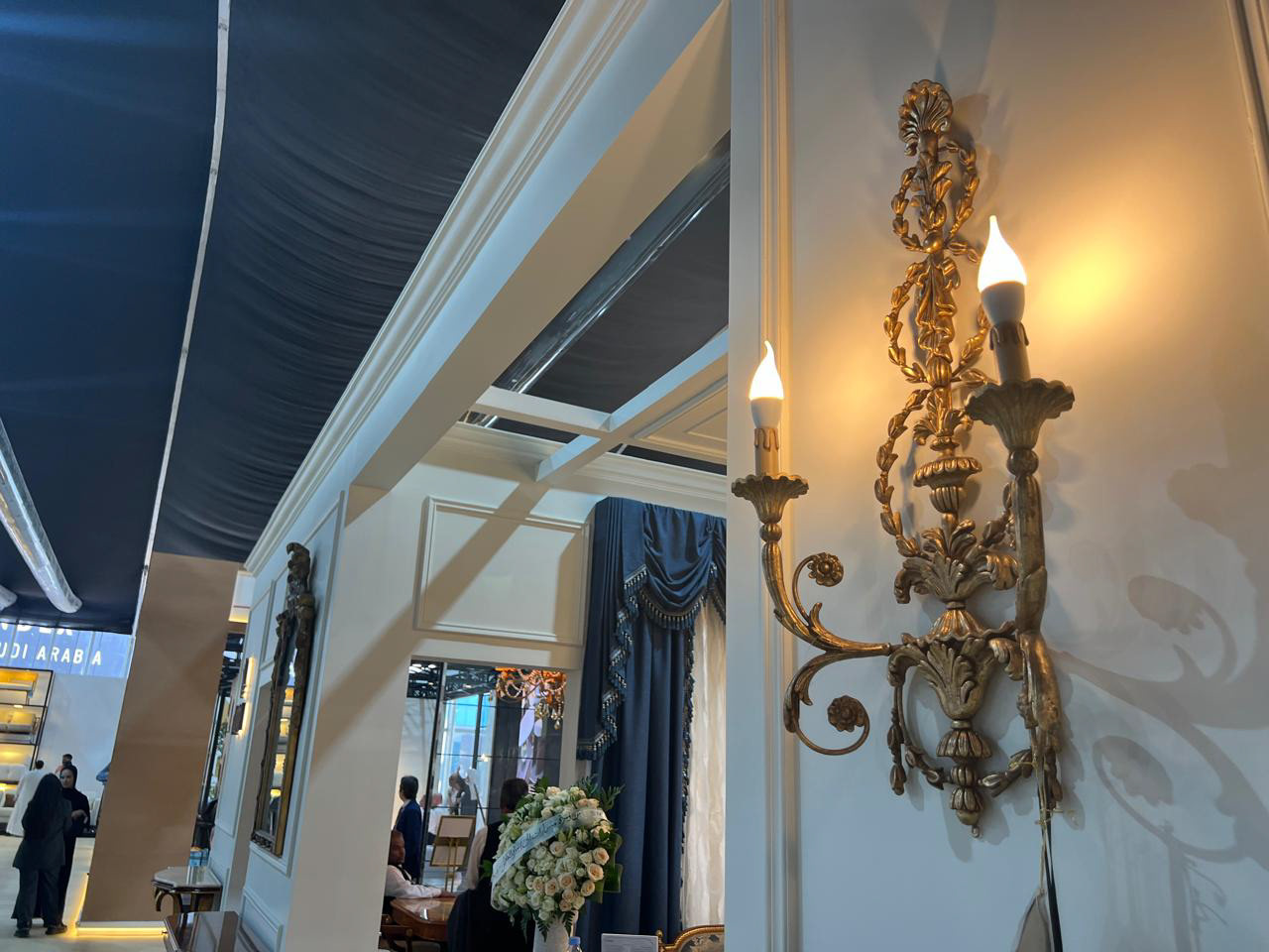 Close-up shot from the right side of the Al Mukmal booth, highlighting intricate architectural details and modern design.