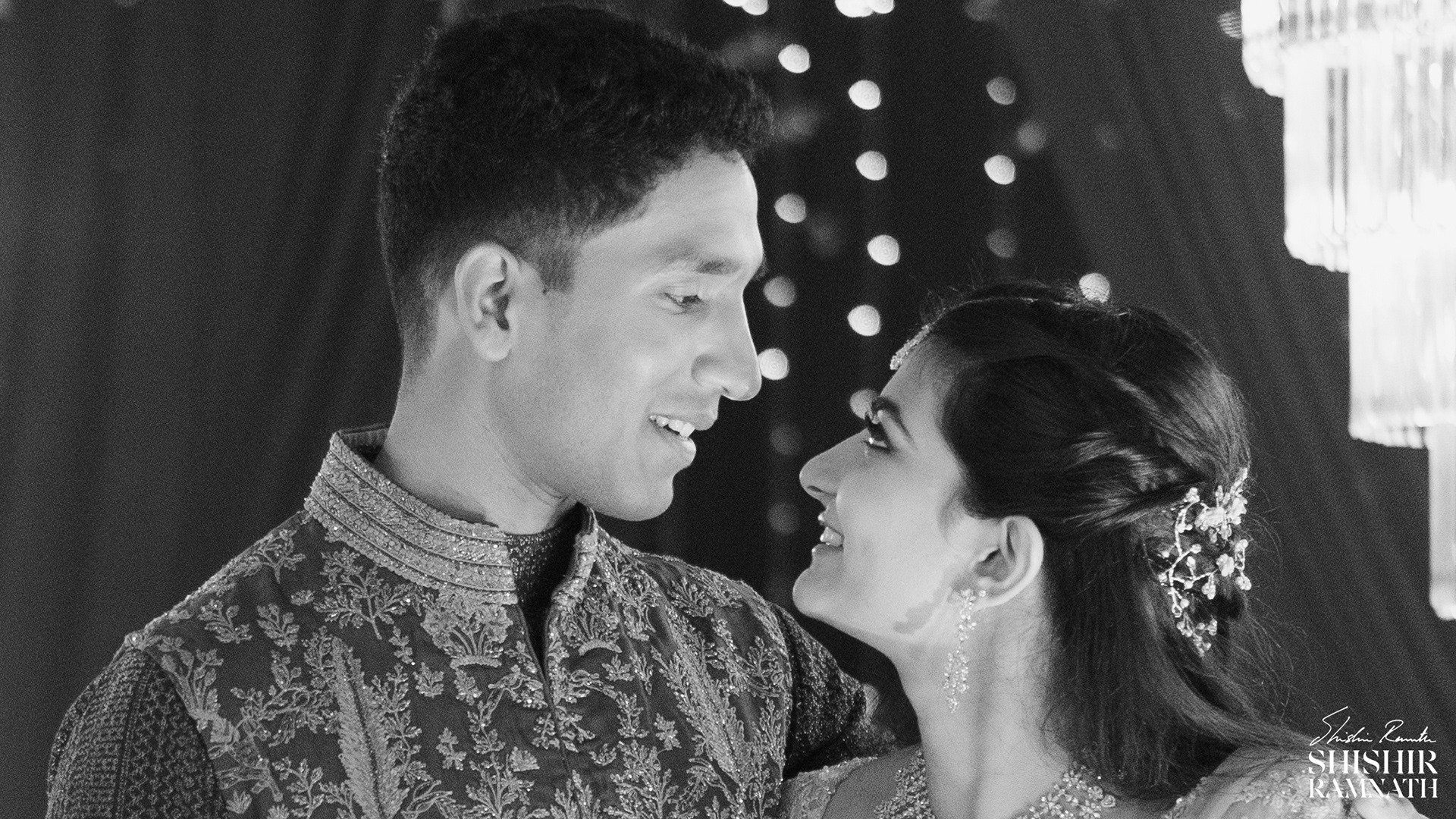 bride and groom look at each other durig a wedding portrait session