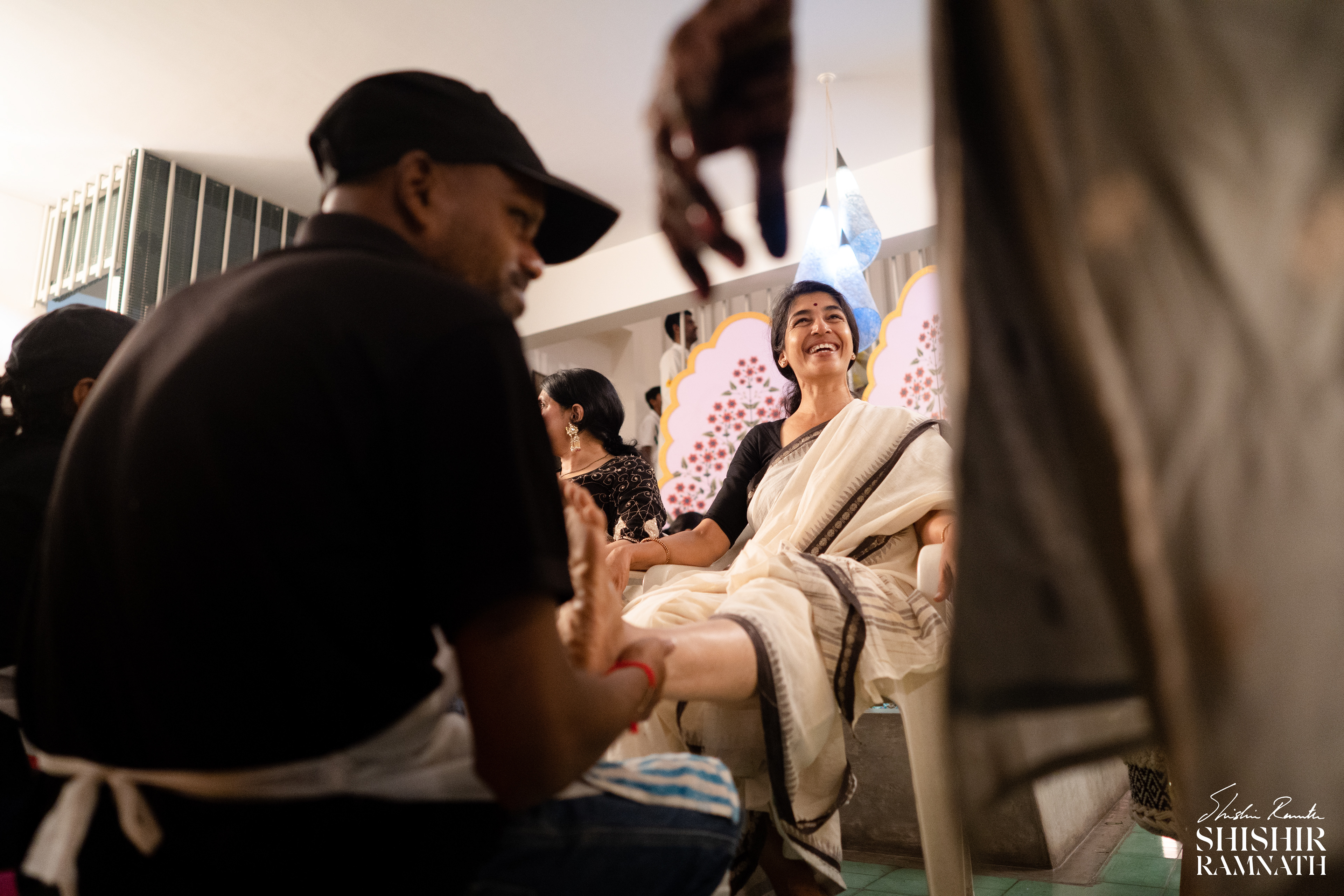 wide angle shot of a woman receiving a leg massage at a pre wedding event