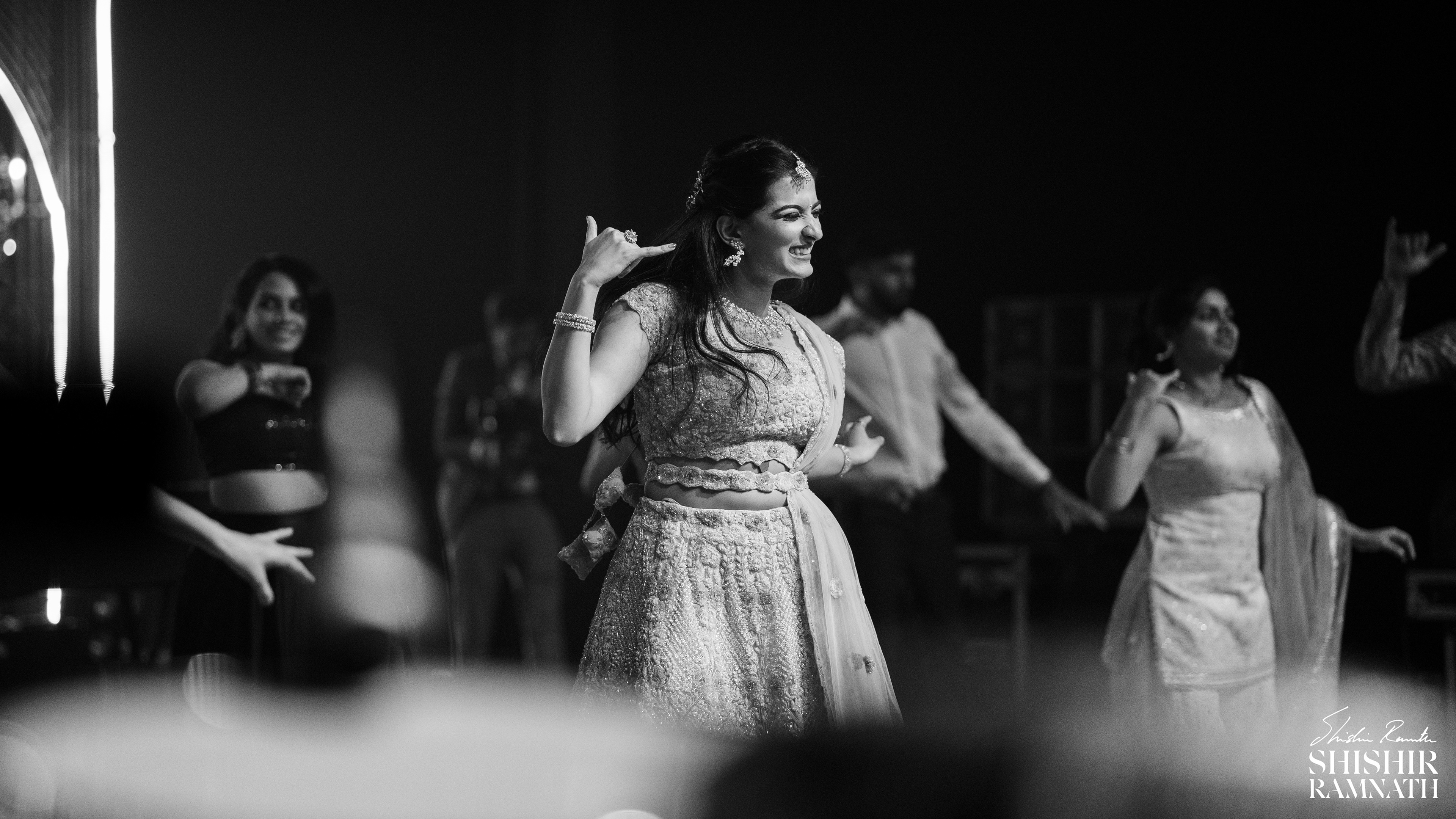 bride bringing in some bridal inspo with her dance moves at a sangeet