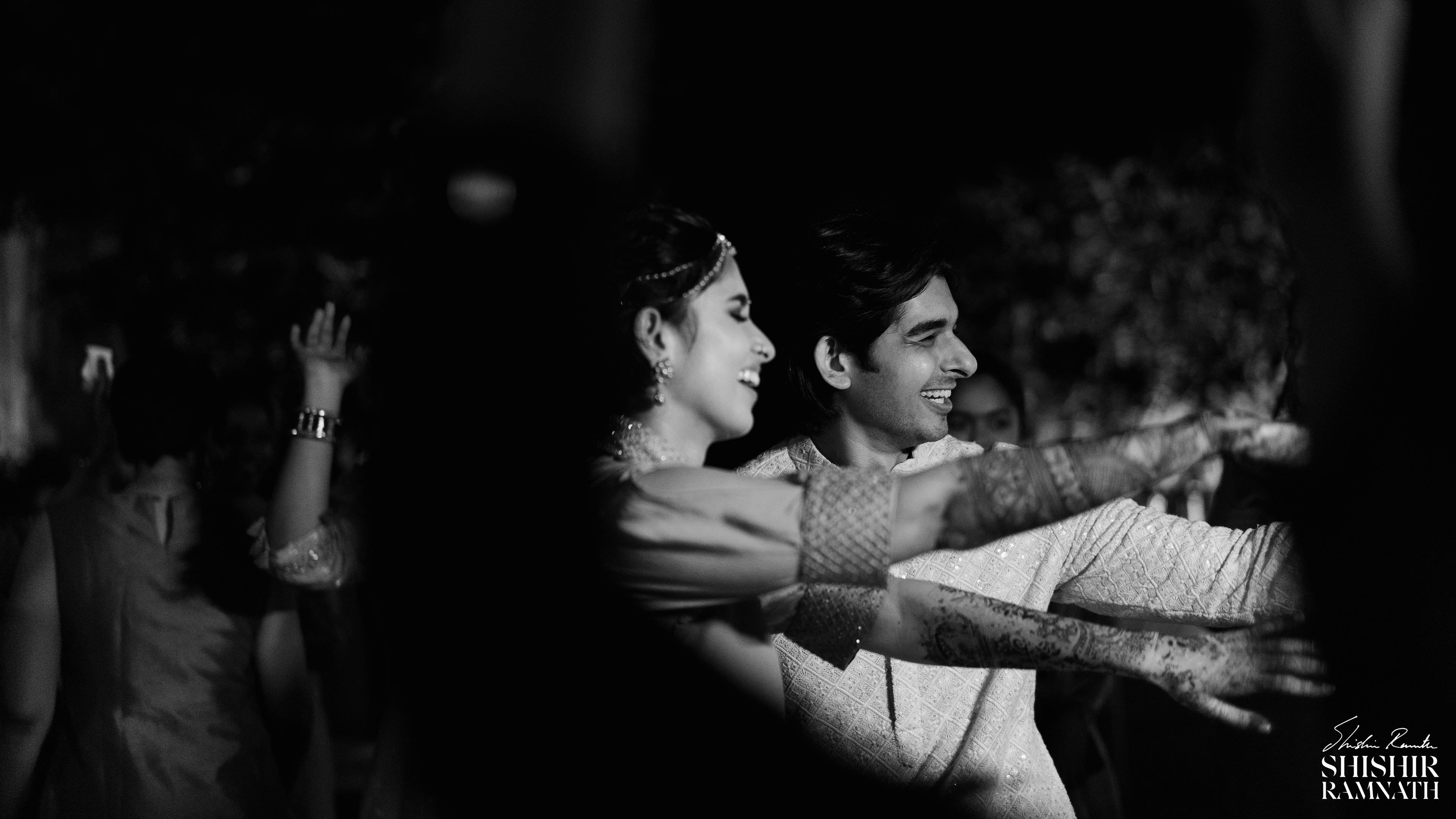 a couple dancing their hearts out at a sangeet event in chennai shot by shishir ramnath in black and white 