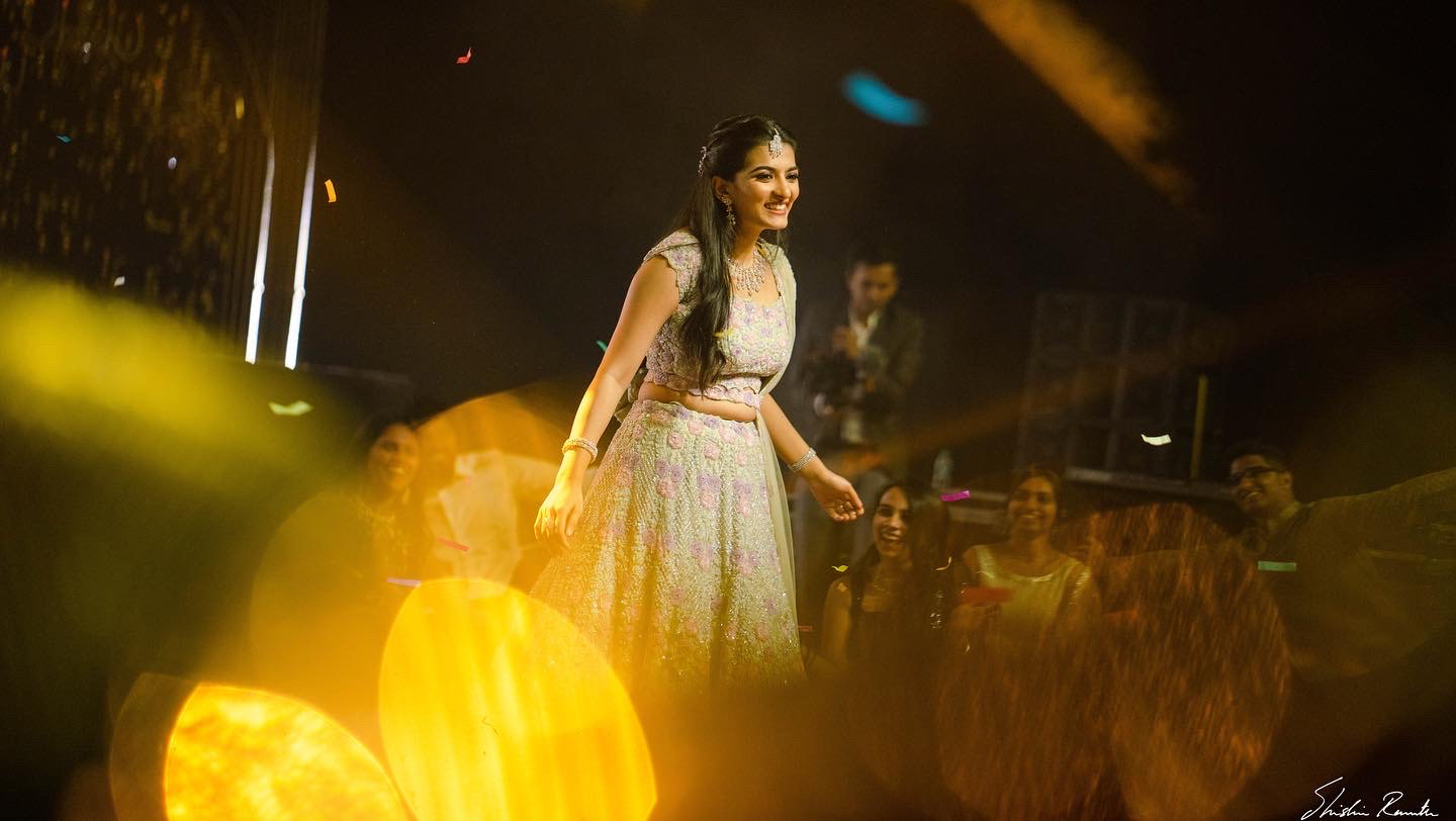 Bride takes a moment to look at the crowd during her dance performance at a sangeet in hyderabad JRC Convention
