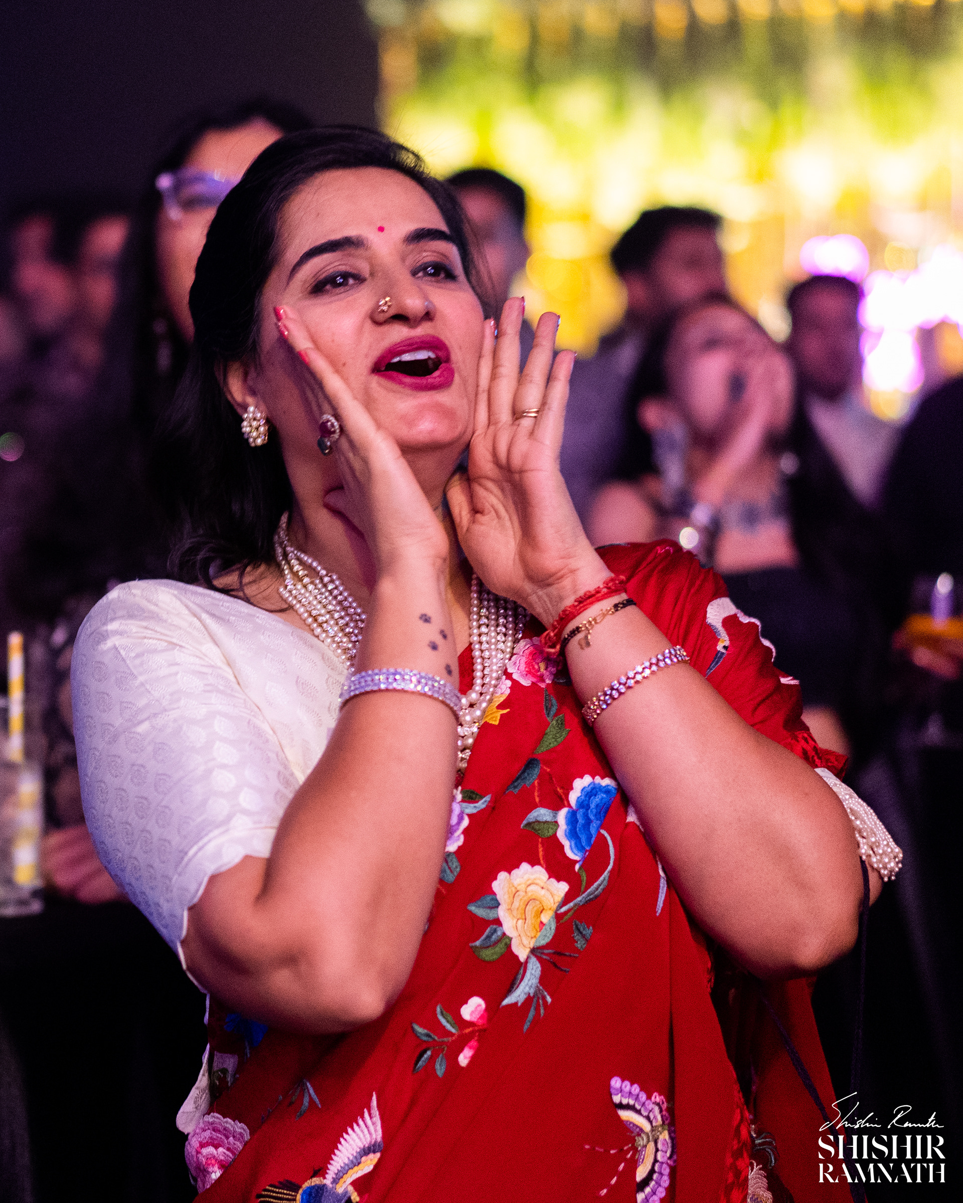 bride's mother cheers her on as she watches her perform at her wedding