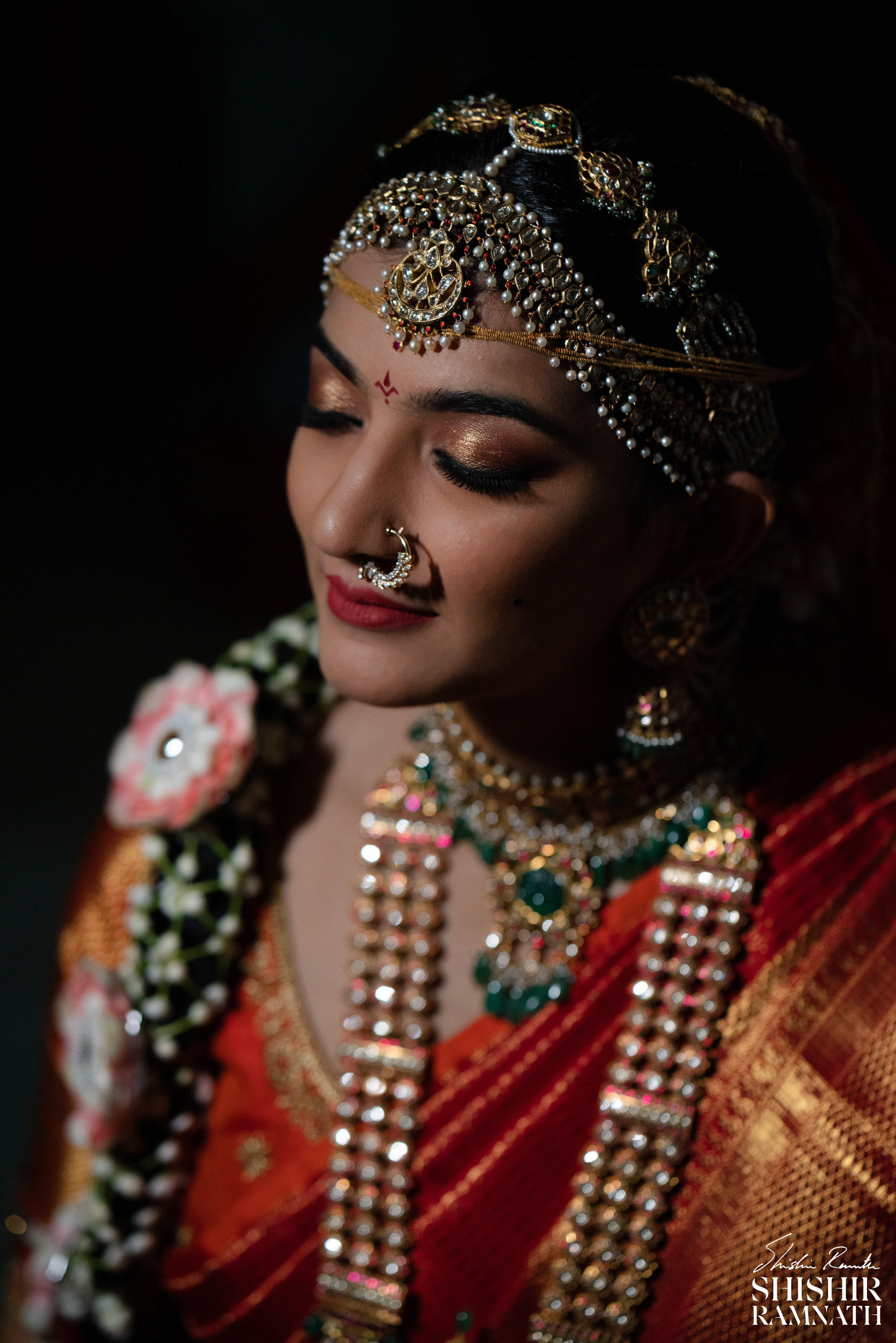 A gorgeous telugu bride posing for the camera right after her bridal makeup is over