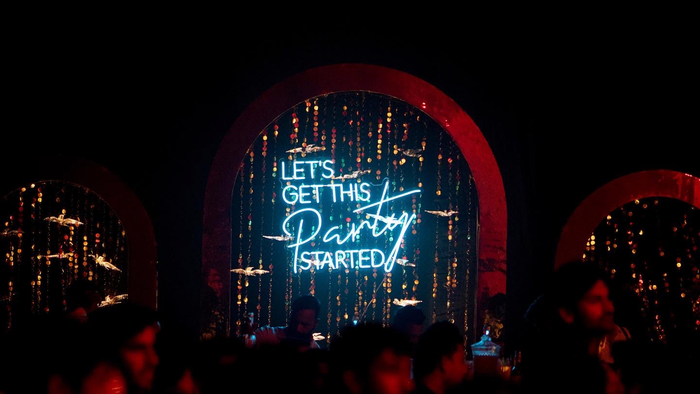 neon lights at a wedding sangeet in hyderabad, india.