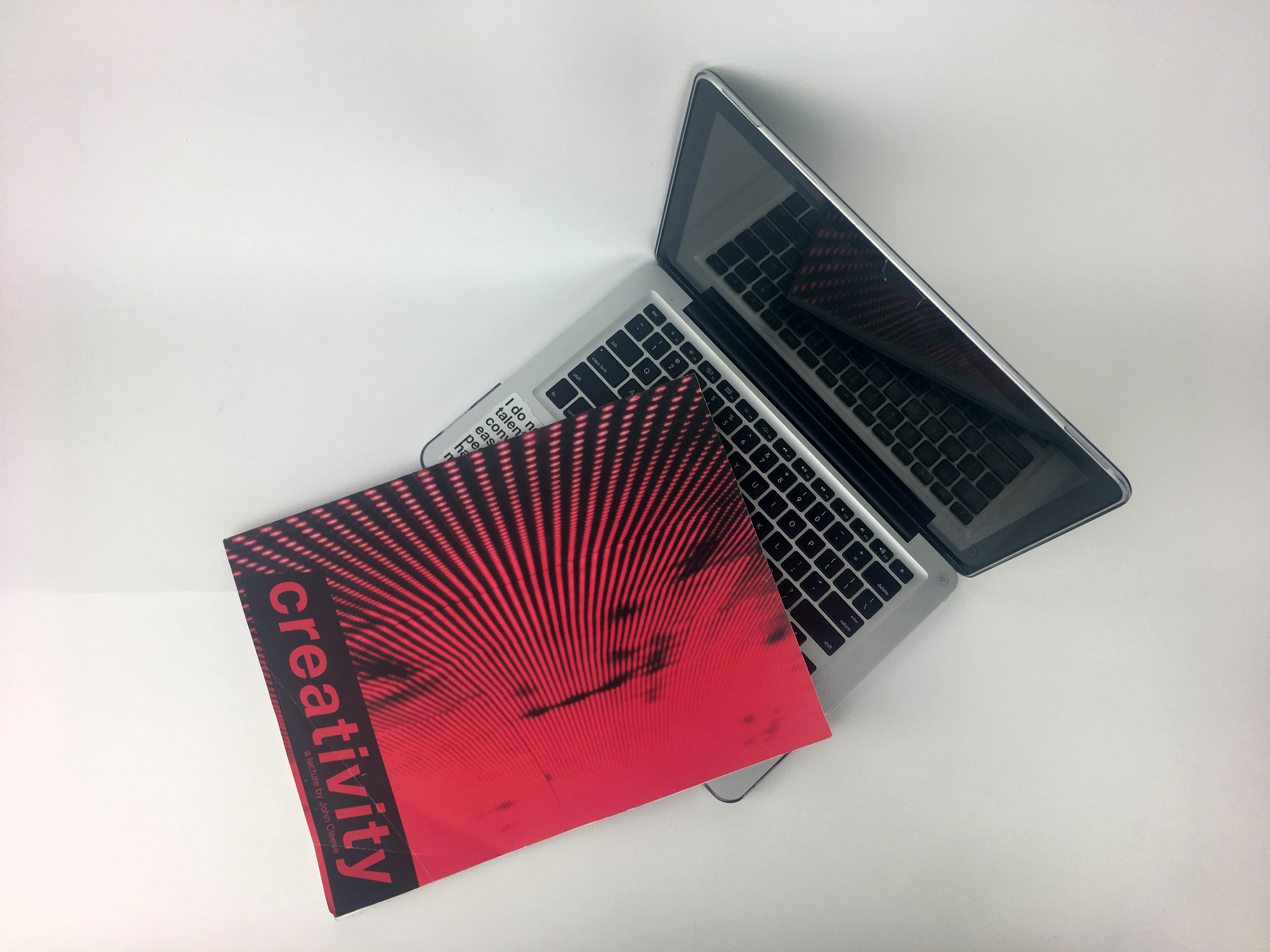 Magazine propped beside a 13-inch Macbook Pro to show scale.