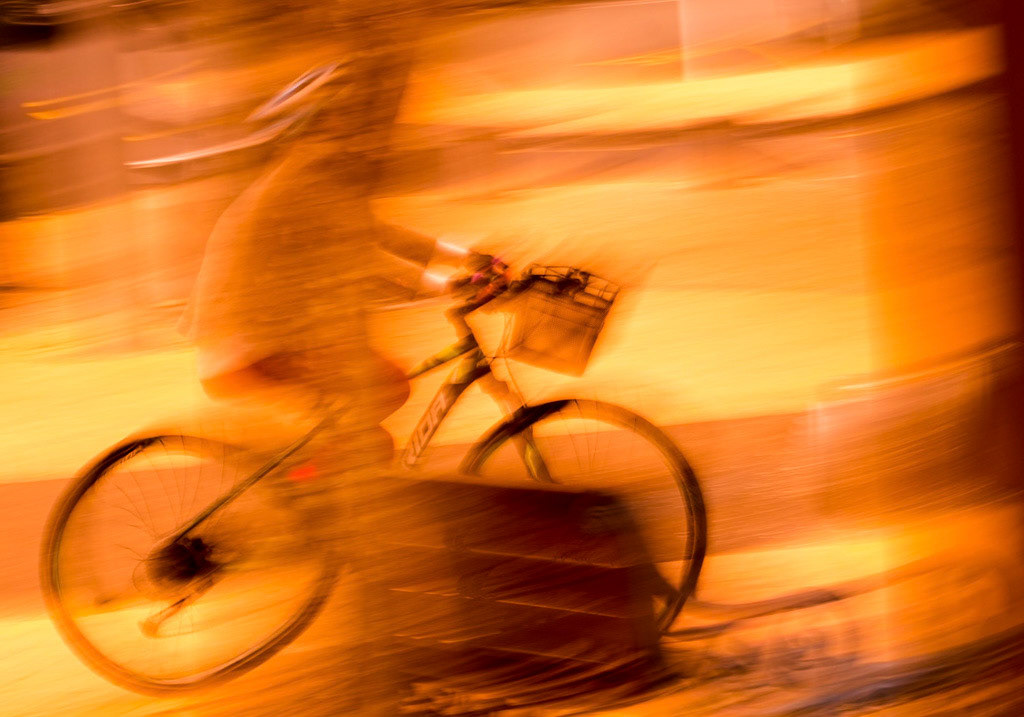 #15  Woman passing on a bicycle