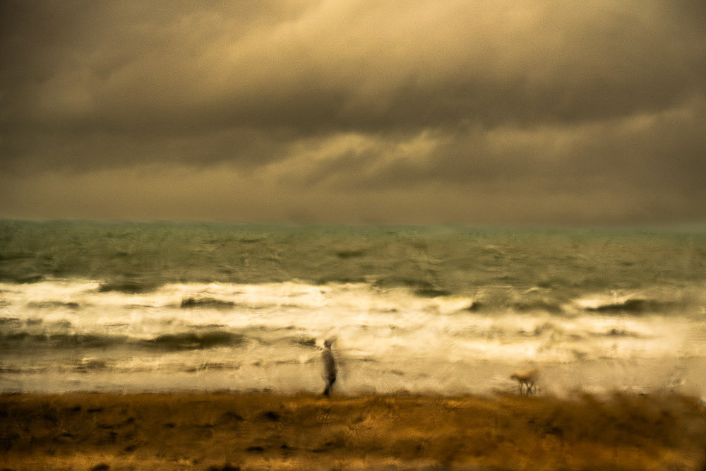 #22  Dog walker on a stormy day  Milford Beach