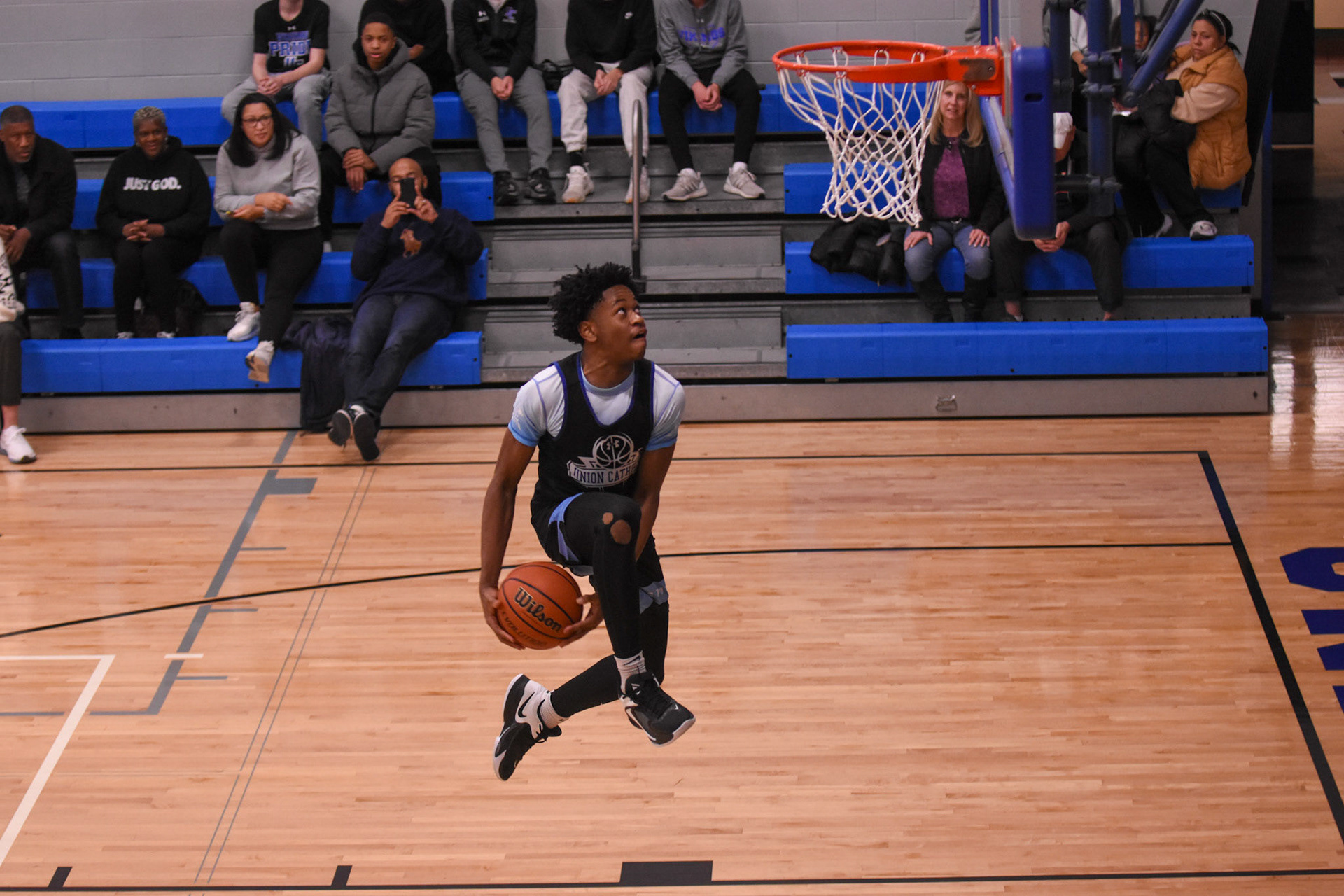 Union Catholic player Malik Moore soars for a dunk during a pep rally.