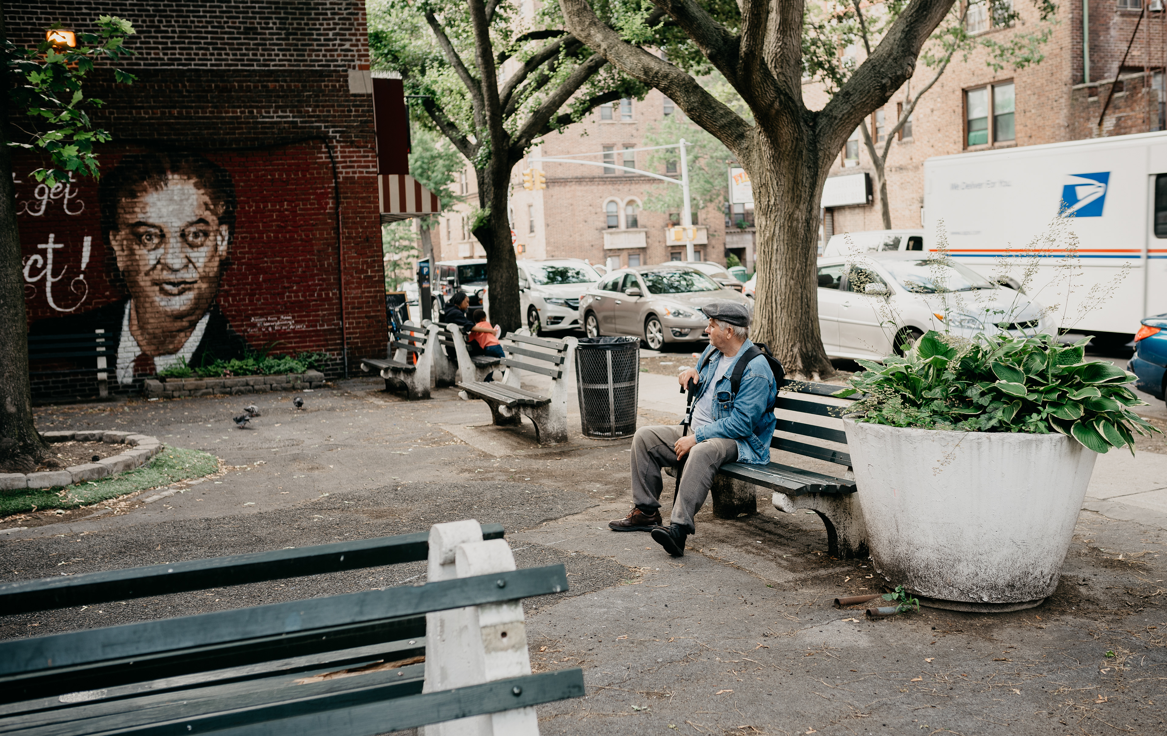 A man takes a break from his afternoon walk to admire a mural of the late comedian Rodney Dangerfield in Kew Gardens, NY, in June 2019. 