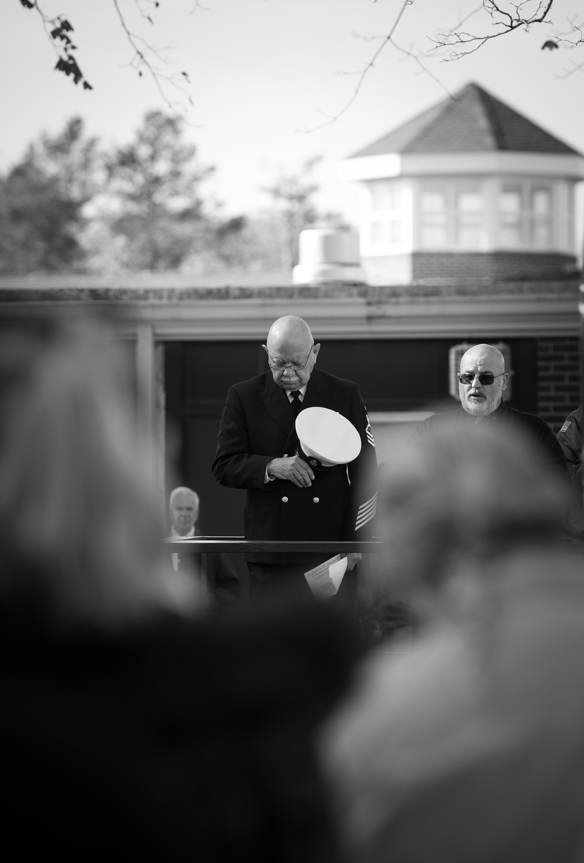 United States Navy Senior Chief Petty Officer Martin Thompson pays his respects during a moment of silence held at the Veterans Day Parade in St. James, NY, on 11/11/21. 