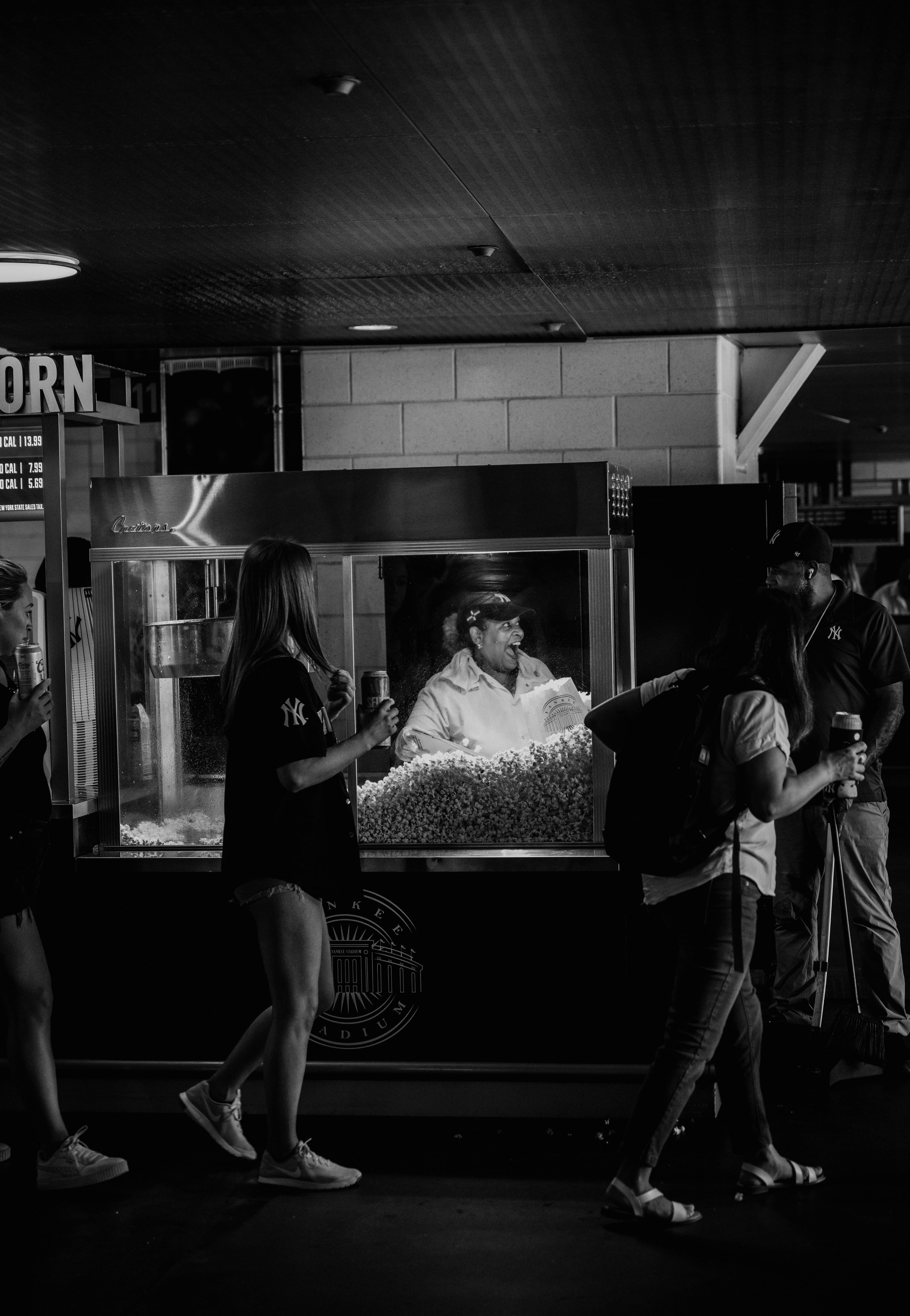 Fans share a cheerful interaction with a popcorn vendor at Yankee Stadium on June 25, 2023.