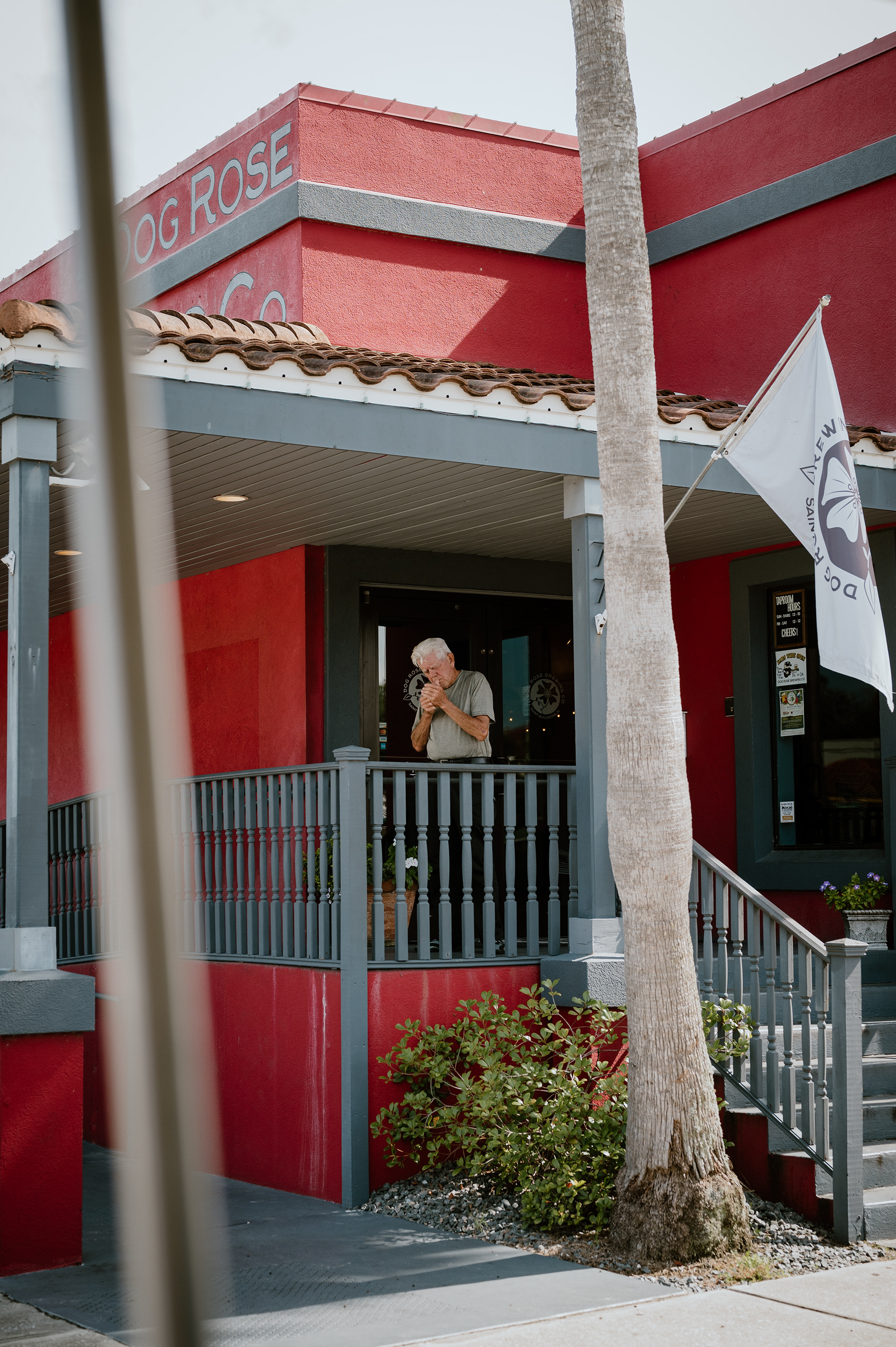 A man lights up a cigarette outside the Dog Rose Brewing Co. in St. Augustine, Florida.