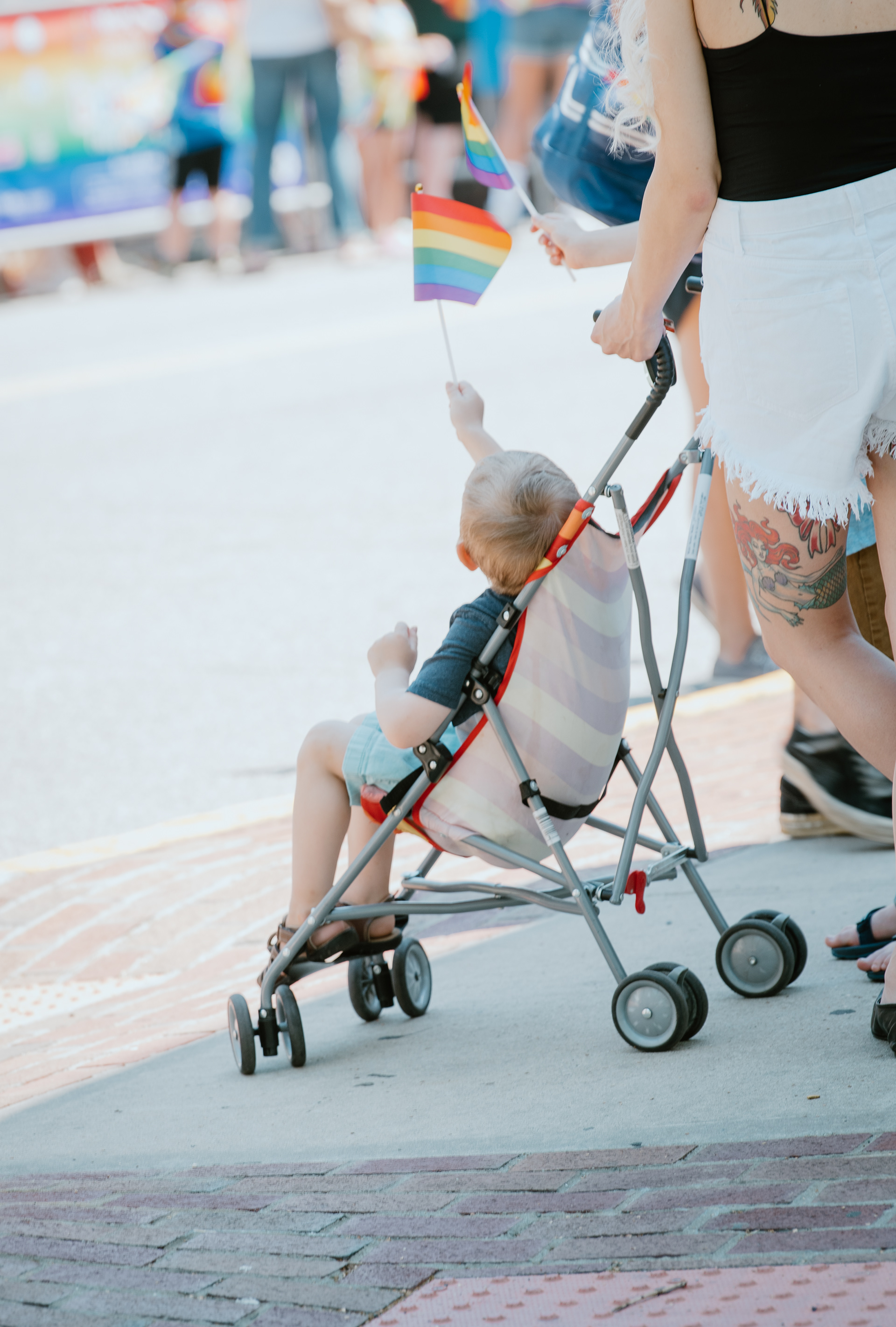 A young boy waves a Rainbow Flag in the air to show support of the colorful LGBTQ-themed floats as they made their way down Deer Park Avenue during the town of Babylon’s annual Pride Parade on June 6, 2021. 
