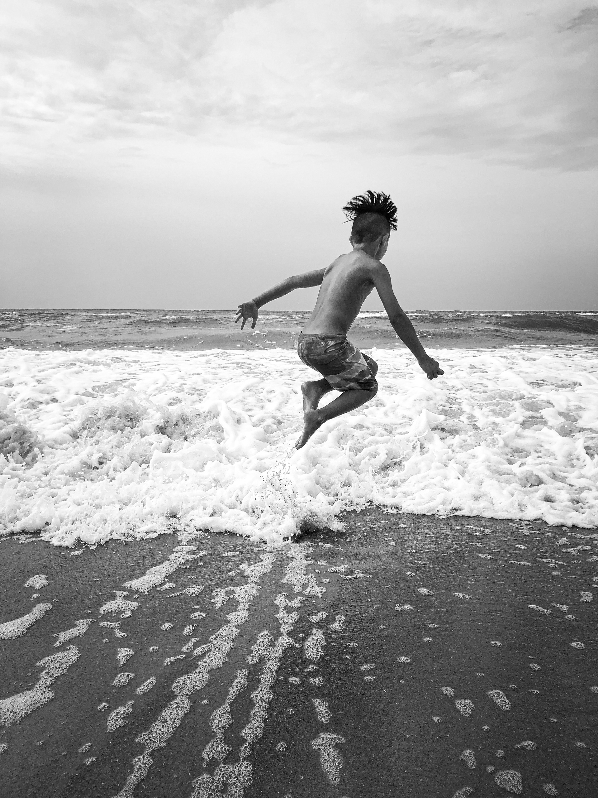 Jaxon Krinsky, 9, jumps over waves to beat the summer heat while on vacation with his family in Emerald Isle, North Carolina.